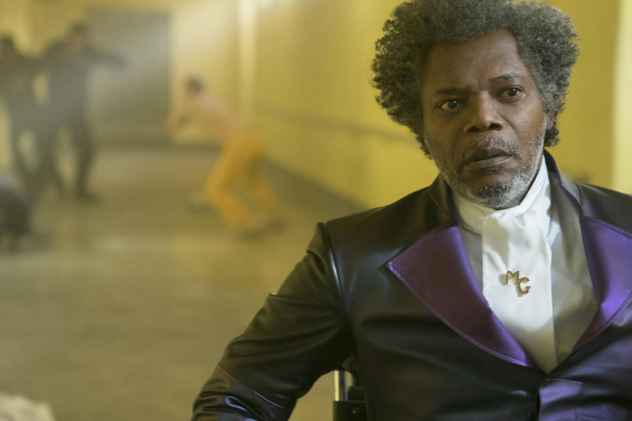 Samuel L. Jackson as Elijah Price/Mr. Glass and James McAvoy (background, in yellow) as Kevin Wendell Crumb/The Horde in "Glass," written and directed by M. Night Shyamalan.