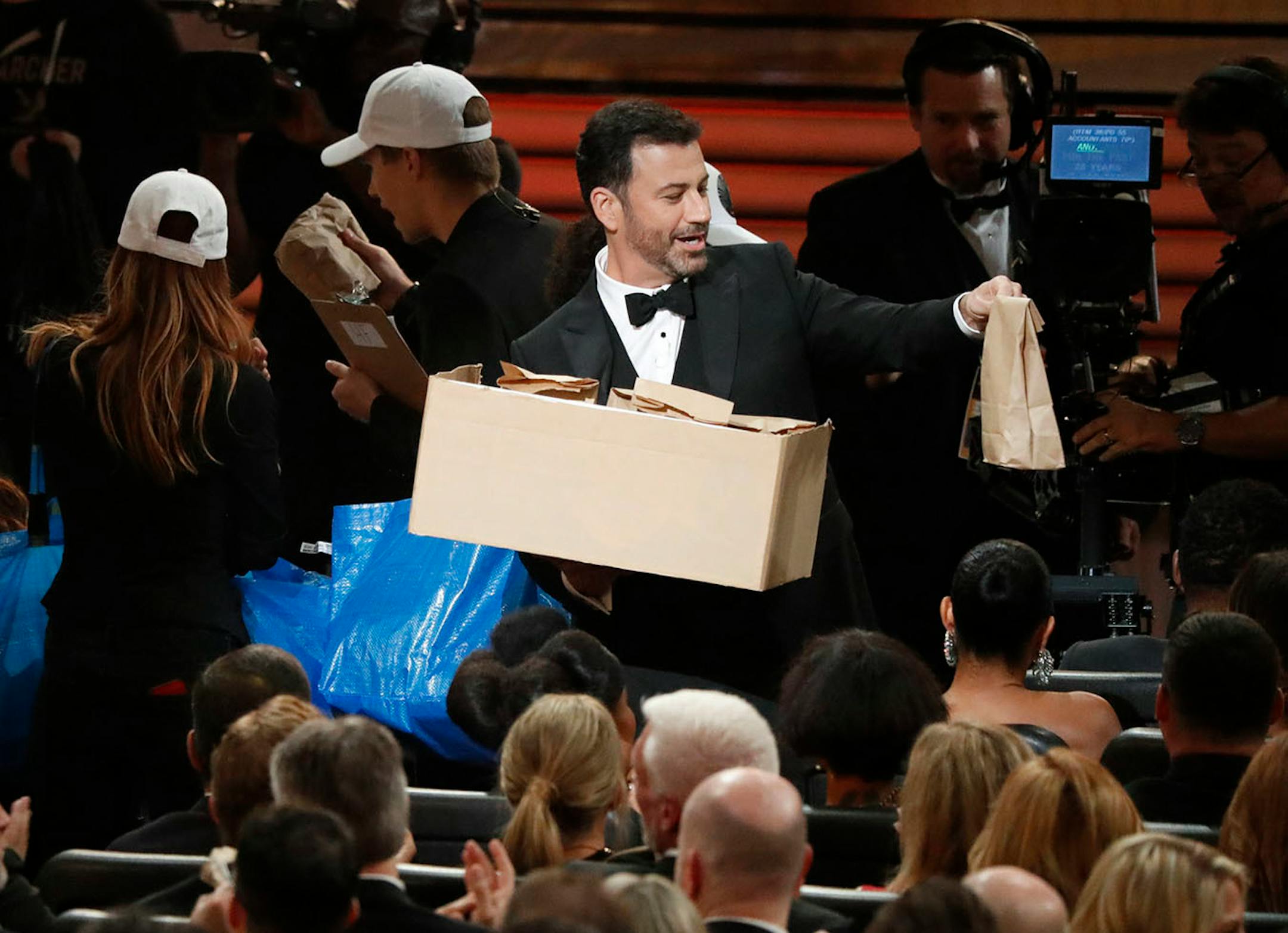 Jimmy Kimmel hands out PBJ sandwiches made by his mother during the 68th Primetime Emmy Awards at the Microsoft Theater in Los Angeles on Sunday, Sept. 18, 2016.
