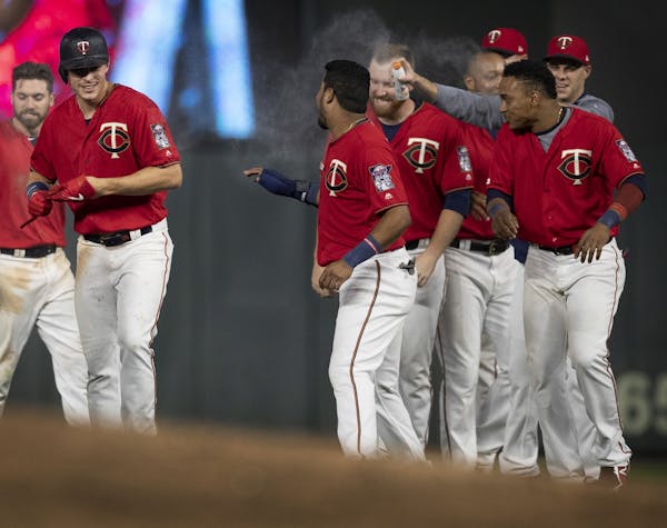Twins players celebrated Minnesota Twins right fielder Max Kepler (26) single in the 17 inning scoring Luis Aaraez for the win at Target Field early W