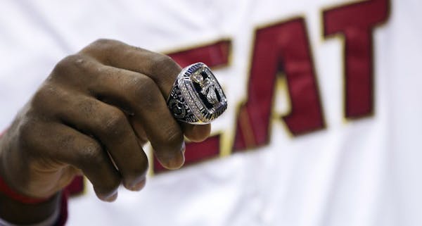 LeBron James holds his 2012 NBA Finals championship ring during a ceremony before a game against the Boston Celtics.