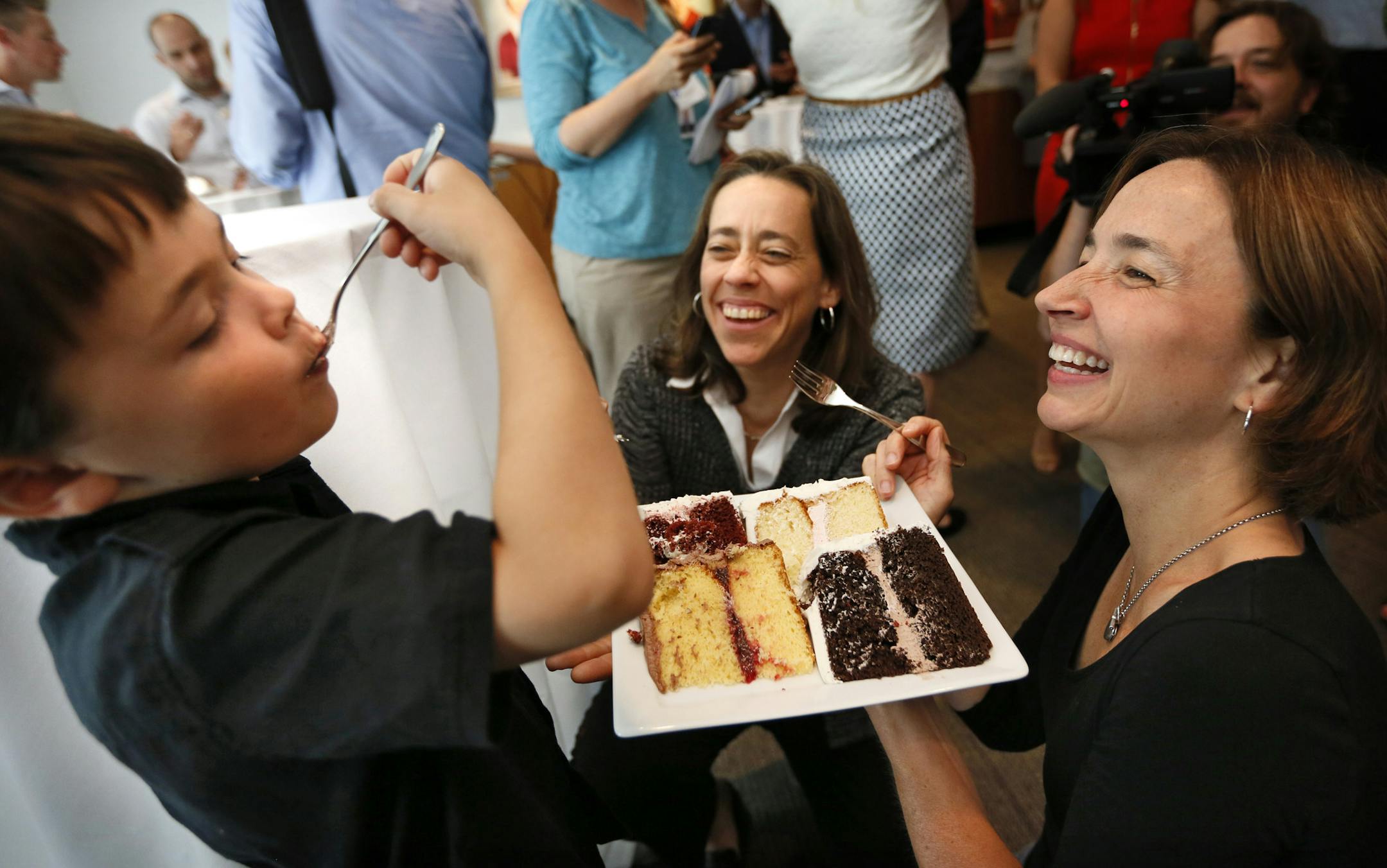 Three of the first couples to legally marry in Minnesota on Aug. 1 visited the Betty Crocker test kitchens to taste wedding cakes for their ceremony. Here, Cathy ten Brooke, center, and Margaret Miles (who will be the first to marry in Minneapolis), get some help from ten Brooke's 5-year-old son, Louie, in choosing a cake. He chose chocolate.