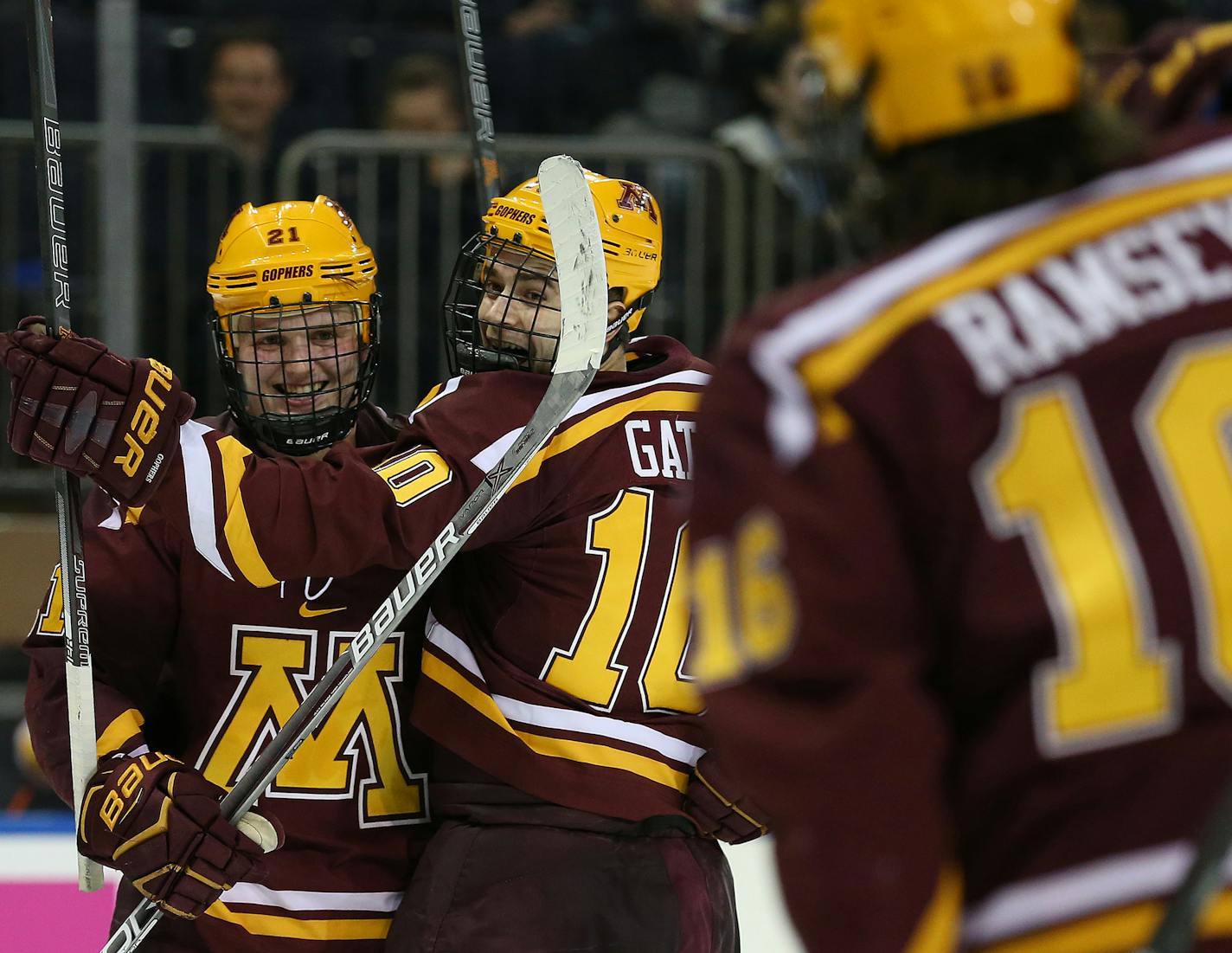 SPECIAL TO MINNEAPOLIS STAR TRIBUNE -- Minnesota Golden Gophers forward Brent Gates Jr. (10) celebrates with teammates Mittelstadt (21) and Jack Ramsey (16) after scoring a goal against the Michigan State Spartans during the third period of a hockey game at Madison Square Garden. Saturday, Jan. 20, 2018, in New York. Minnesota defeated Michigan State 2-1. (AP Photo/Rich Schultz) ORG XMIT: NYRS210