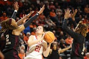 Nebraska forward Annika Stewart (21) looks to shoot between Texas A&M forwards Janiah Barker (2) and Maliyah Johnson during the first round of the NCA