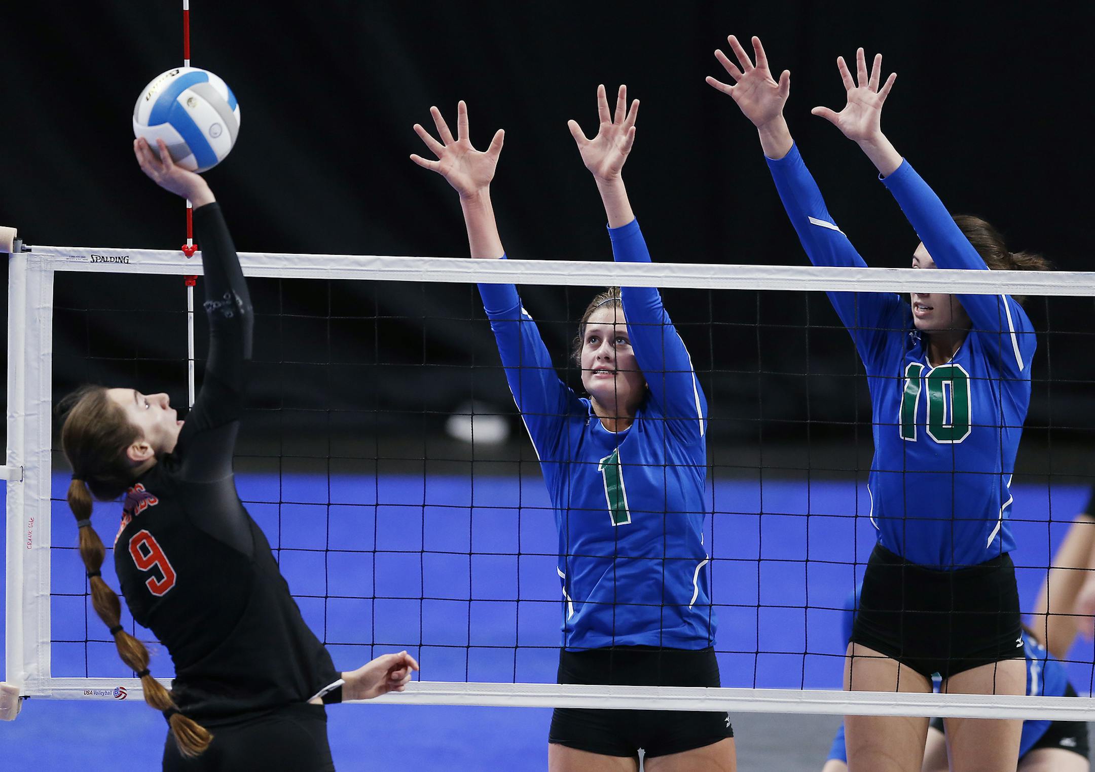 Grand Rapids' Megan Walsh (9) hits the ball as Eagan's McKenna Melville (1) and Eagan's Alyssa Doucette (10) block. ] (Leila Navidi/Star Tribune) leila.navidi@startribune.com BACKGROUND INFORMATION: Eagan High school against Grand Rapids High School in the Class 3A volleyball quarterfinals at the Xcel Energy Center in St. Paul on Thursday, November 10, 2016.