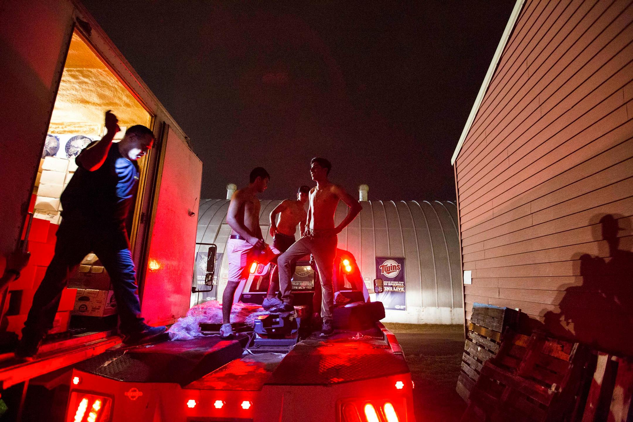 Workers from Mickey's Grill, which serves turkey legs and meat kebabs, stock 500 boxes of turkey legs into a refrigerated truck after midnight on Wednesday, September 2, 2015. The 500 boxes will be enough to get them through the rest of the Minnesota State Fair. The workers all come from Brownsville, Texas and travel all over the country to different fairs serving turkey legs and other fair food. ] LEILA NAVIDI leila.navidi@startribune.com /