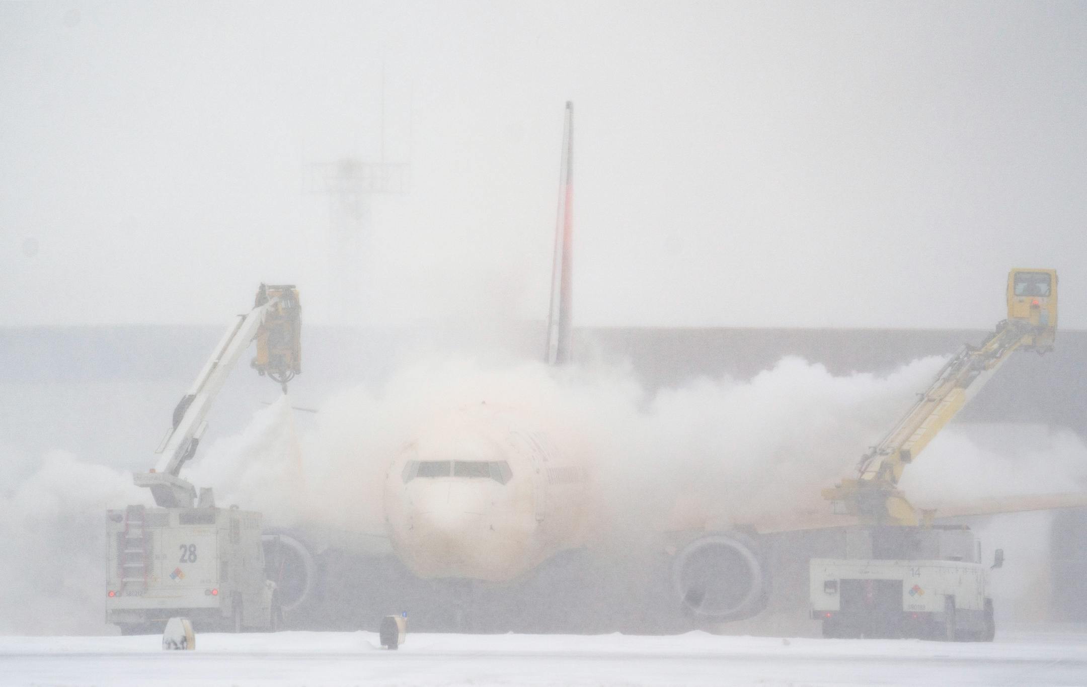 A plane is de-iced at Minneapolis-Saint Paul International Airport.