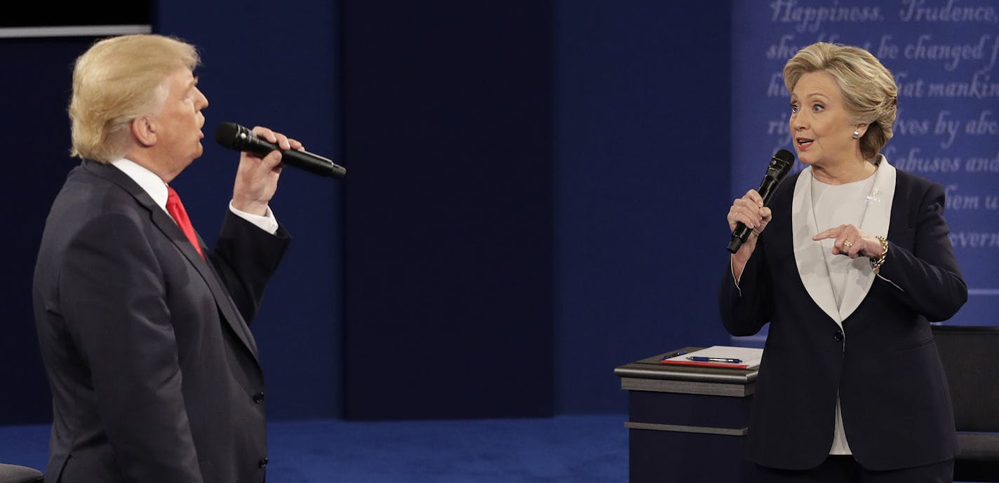 Republican presidential nominee Donald Trump and Democratic presidential nominee Hillary Clinton speak during the second presidential debate at Washington University in St. Louis, Sunday, Oct. 9, 2016. (AP Photo/John Locher) ORG XMIT: MIN2016101012410620