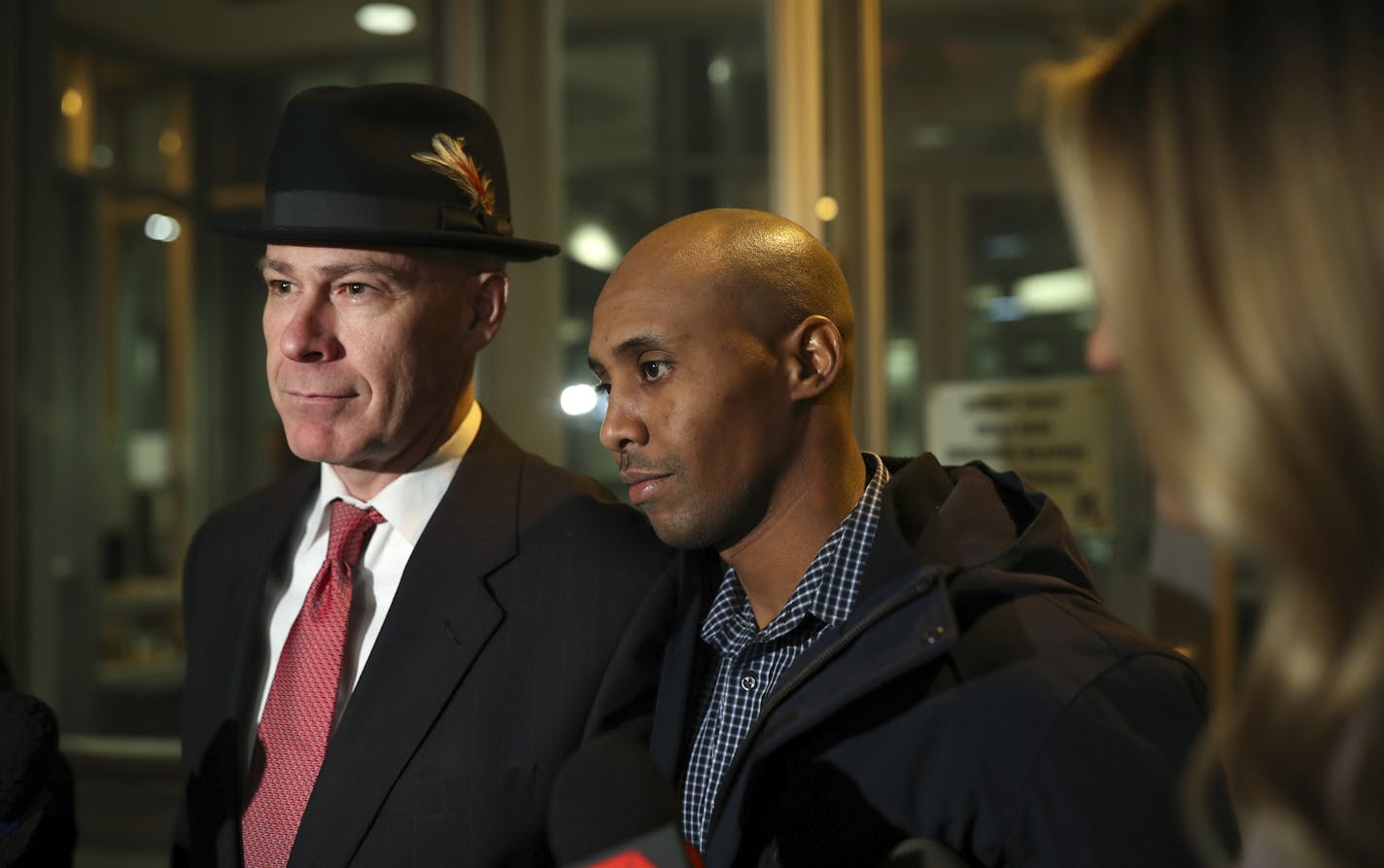 Former Minneapolis Police Officer Mohamed Noor leaves the Hennepin County Public Safety Facility with his attorney, Thomas Plunkett, left, after posting bail Wednesday night, March 21, 2018, in Minneapolis. Noor is charged with murder and manslaughter in the July death of Justine Ruszczyk Damond, who had called 911 to report a possible sexual assault behind her home.