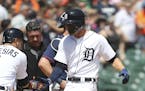 Detroit Tigers' JaCoby Jones, right, is greeted at home plate by Jose Iglesias (1) after hitting a two-run home run during the seventh inning of a bas