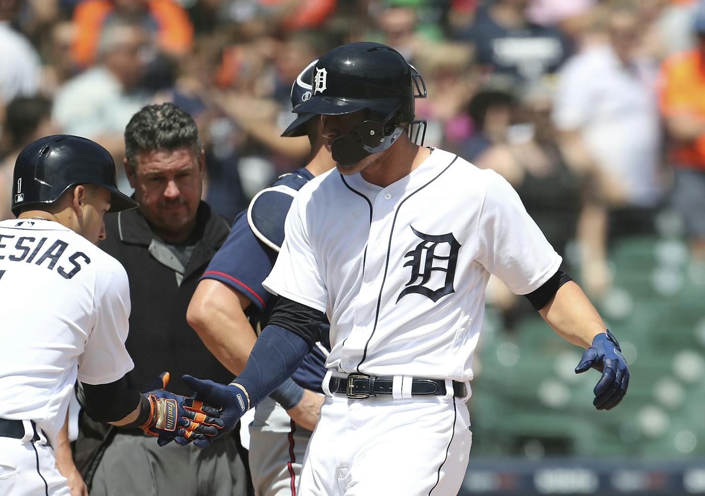 Detroit Tigers' JaCoby Jones, right, is greeted at home plate by Jose Iglesias (1) after hitting a two-run home run during the seventh inning of a baseball game against the Minnesota Twins, Thursday, June 14, 2018, in Detroit. (AP Photo/Carlos Osorio)