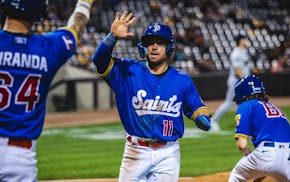Payton Eeles arrives home to congratulations during a St. Paul Saints game.