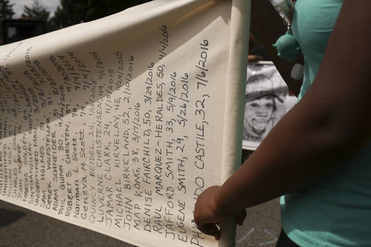 Activists unfurled a scroll with Philando Castile's name at a rally outside the St. Anthony Police Department on July 10, 2016, one of several protests in the Twin Cities that day.