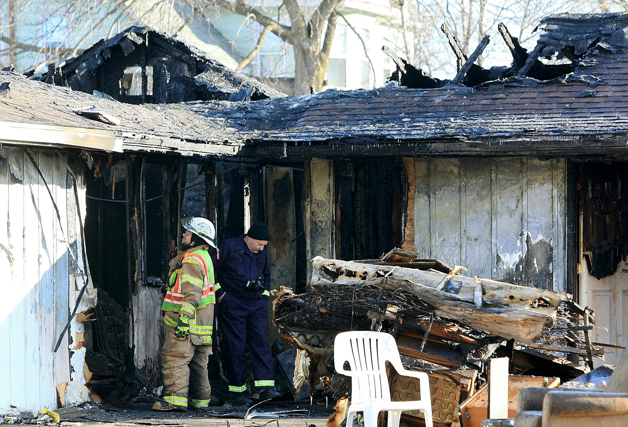 Investigators search the scene of a fatal fire at the Downtown Motel in St. Charles, Minn. on Friday, Dec. 7, 2012. Authorities say one person was found dead in the motel fire. Police say 47-year-old Vincent Edward Wright, of Avon, S.D., had checked into the Downtown Motel earlier Thursday and was the only one registered to the room. Three other motel guests escaped unharmed when fire broke out about 11 p.m. (AP Photo/The Winona Daily News, Andrew Link) MANDATORY CREDIT