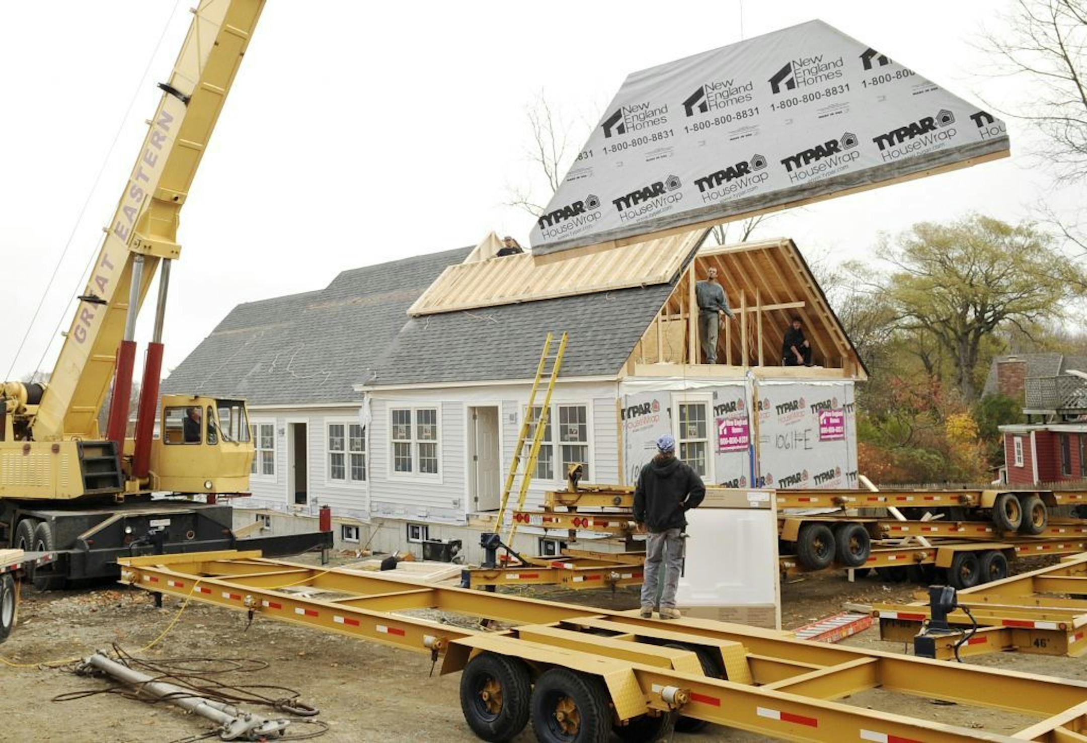 In this Nov. 10, 2009 photo, a prefabricated home is pieced together in Rockport, Mass. A key gauge of homebuilders' confidence held steady in November, reflecting a cautious outlook from residential developers as they waited to learn whether Congress would extend a homebuyer tax credit.