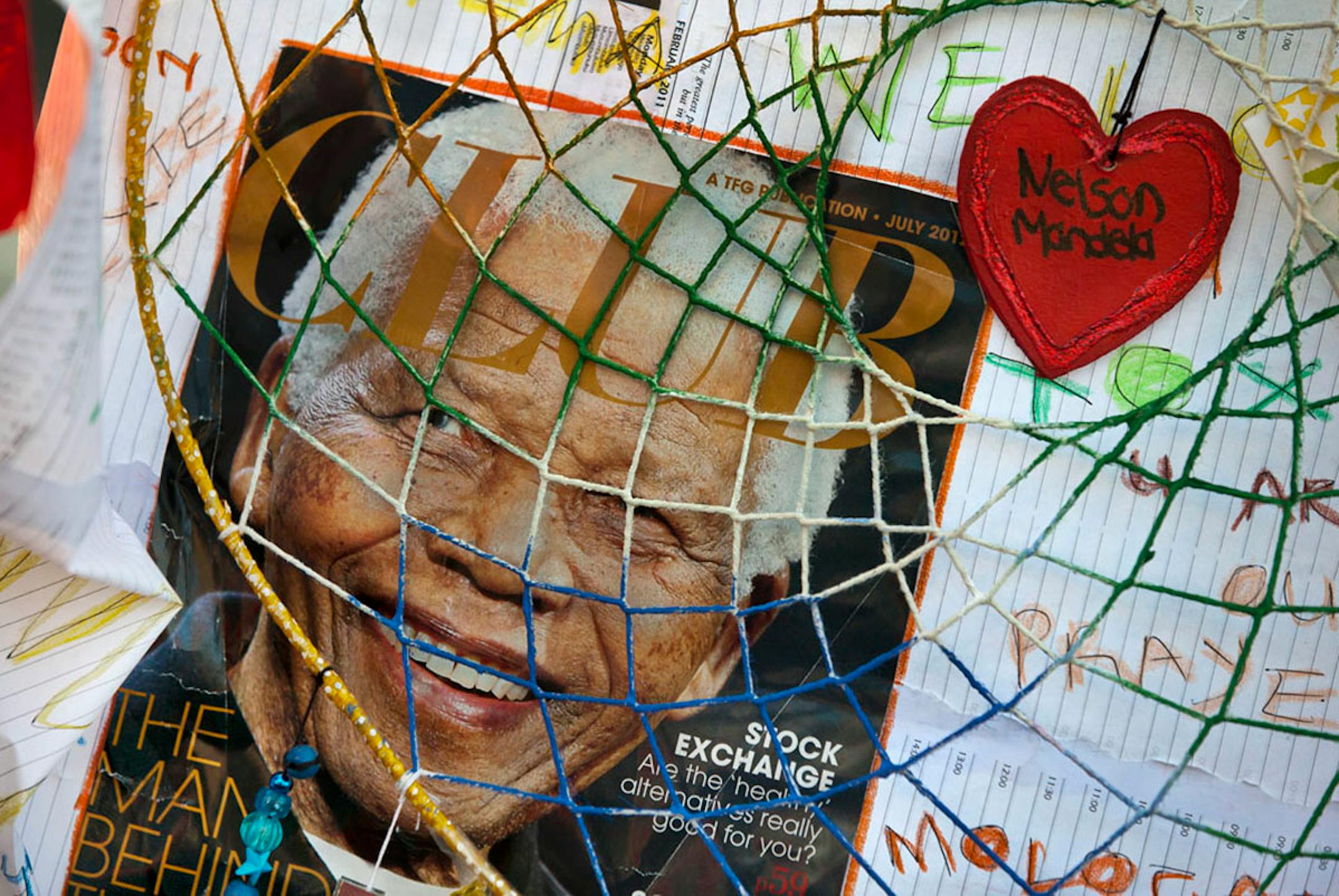 Get-well messages and images of former South African President Nelson Mandela are left by well wishers outside the Mediclinic Heart Hospital where he is being treated in Pretoria, South Africa Saturday.
