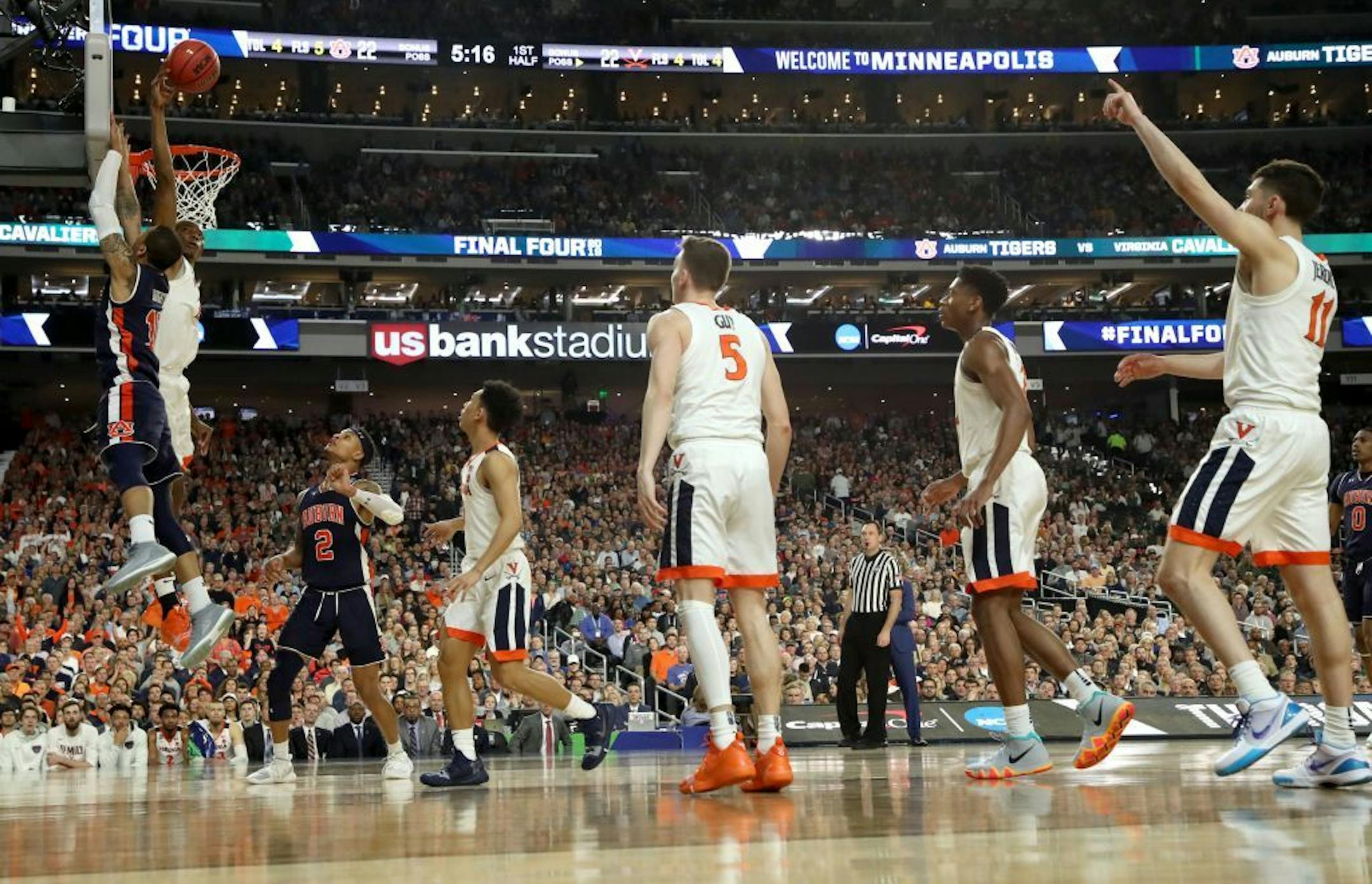 Virginia Cavaliers forward Mamadi Diakite (25) blocked Auburn guard Samir Doughty (10) during the first half.