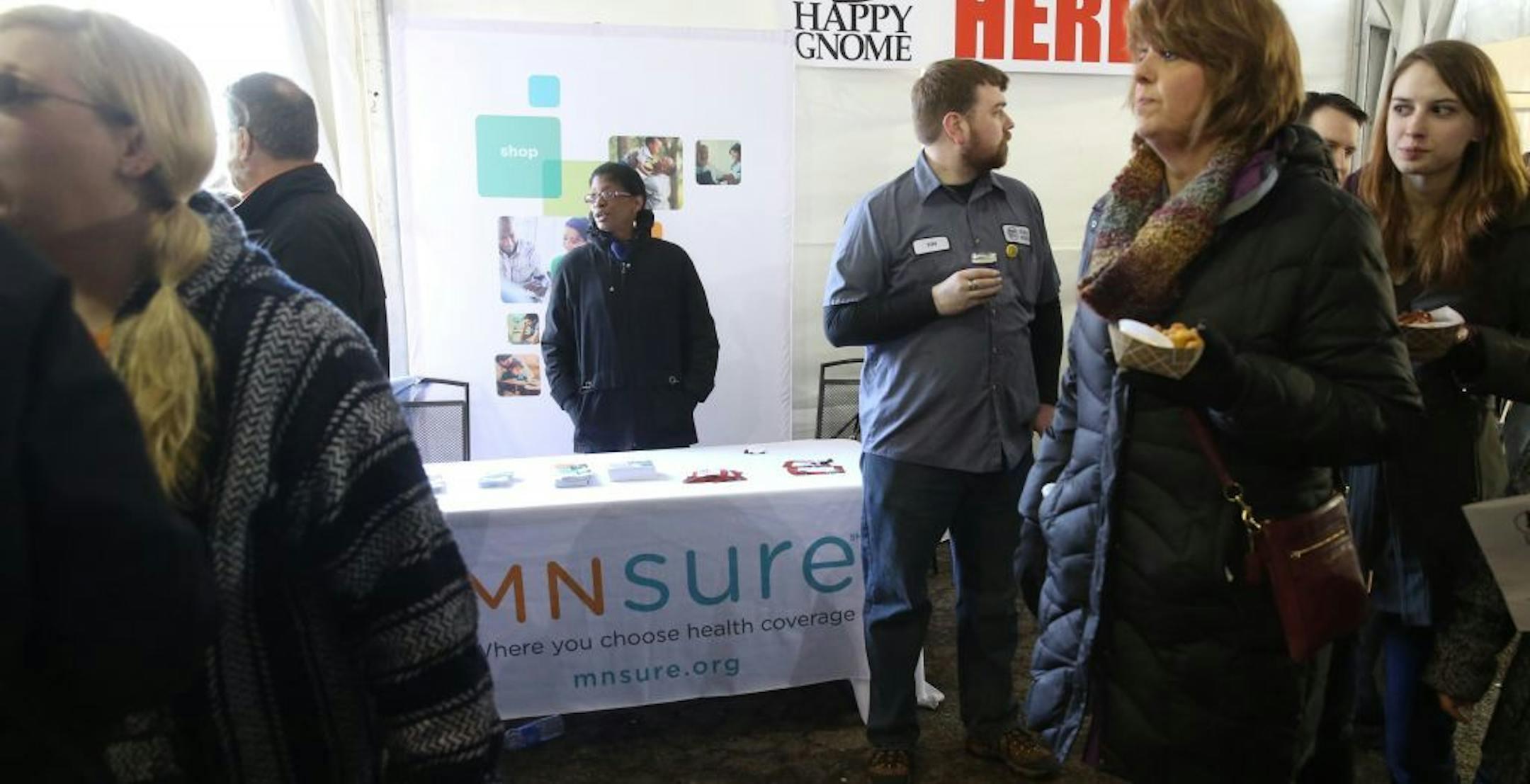 MNsure liason Makela Norris monitored an informational table at the Happy Gnome bar in St. Paul, where the Firkins Fest event was in full swing.