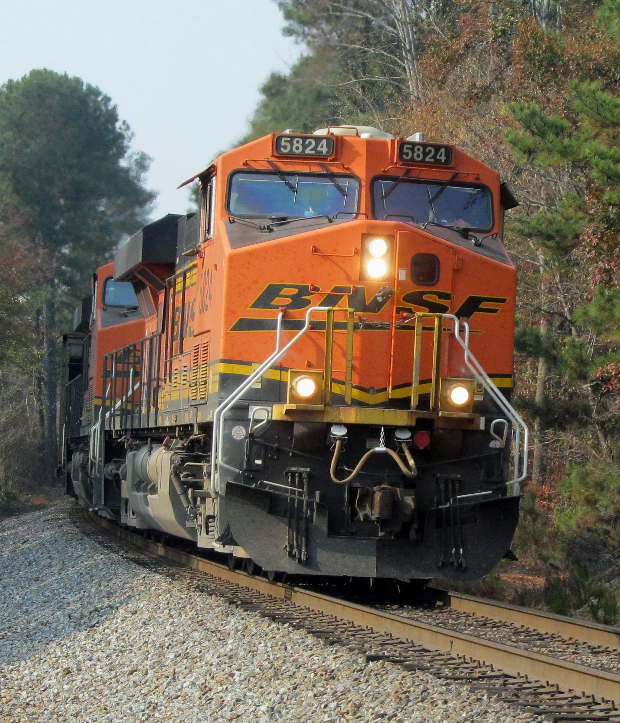 In this November 14, 2016 photo, a Burlington Northern Santa Fe (BNSF) locomotive leads a freight train through Dallas, Ga., November 14, 2106. Locomotive number 5824 is an ES44AC model built by GE Transportation Systems. (AP Photo/Henry Durand)