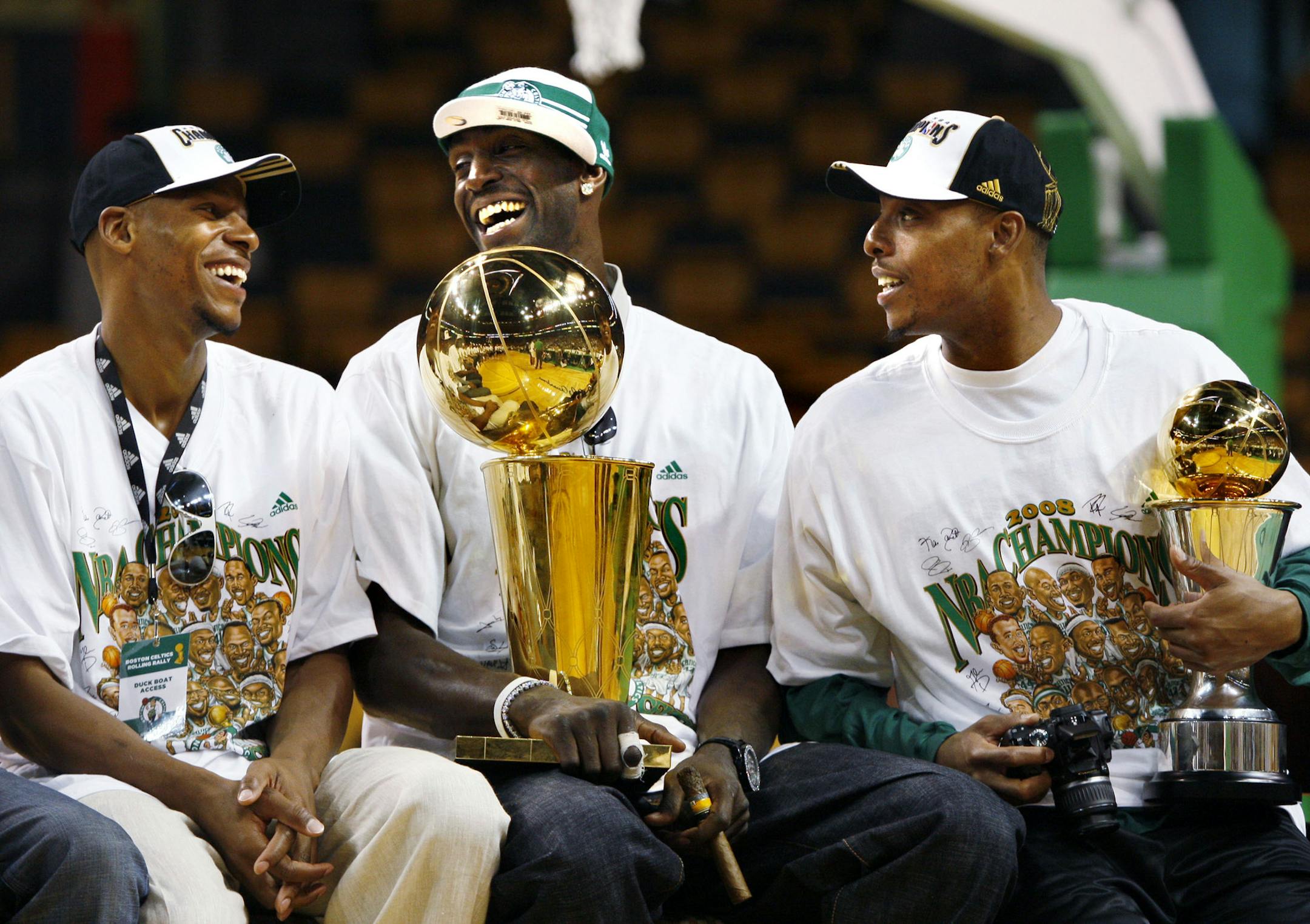 Boston Celtics teammates from left, Ray Allen, Kevin Garnett and Paul Pierce laugh during an event celebrating the team's NBA championship inside the TD Banknorth Garden prior to a rolling rally in Boston Thursday, June 19, 2008. (AP Photo/Elise Amendola)