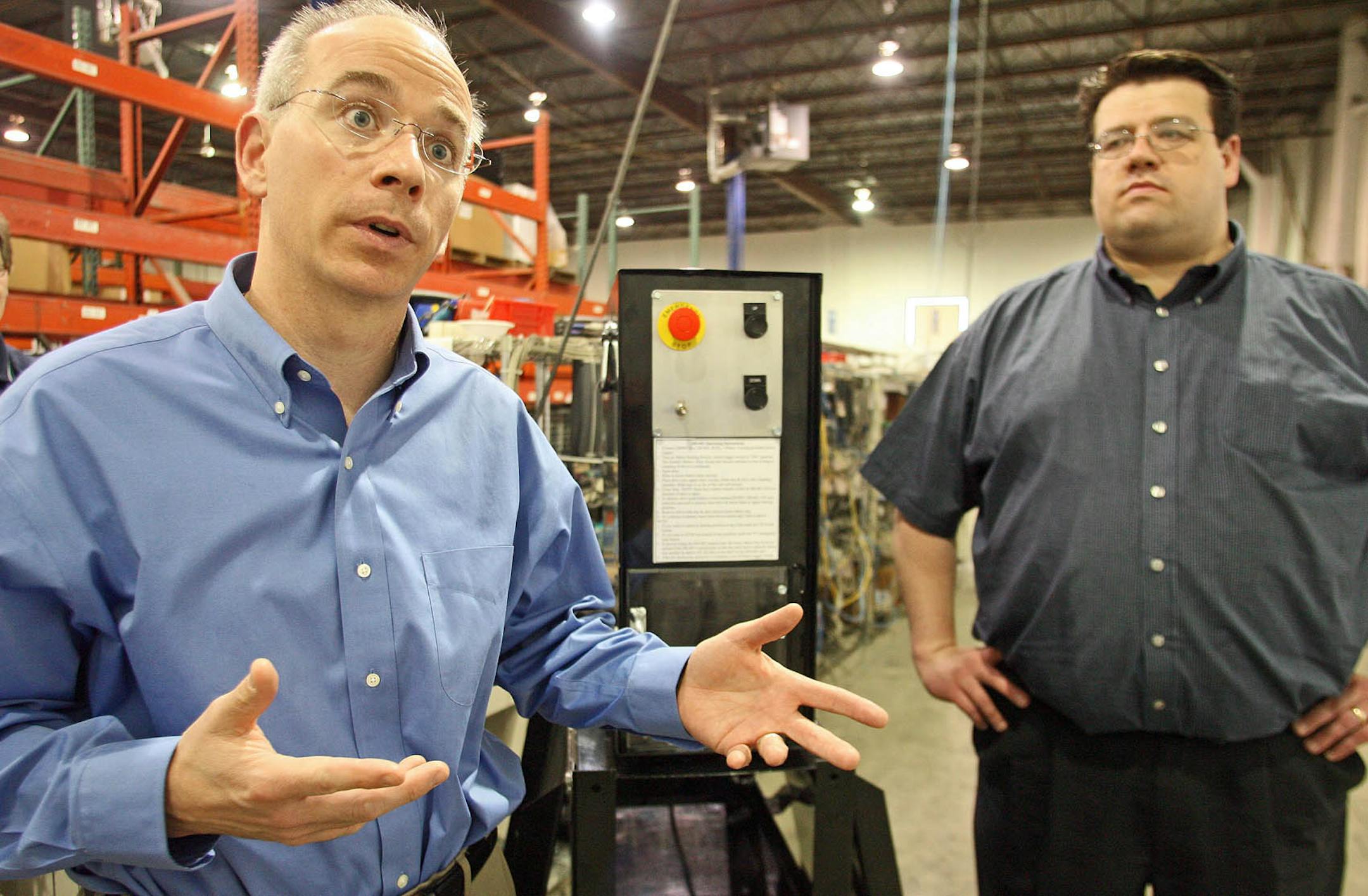 Asset Recovery Corp executives Marshall Johnson, left and Ryan Laber explained the details of the crushing machine, center.