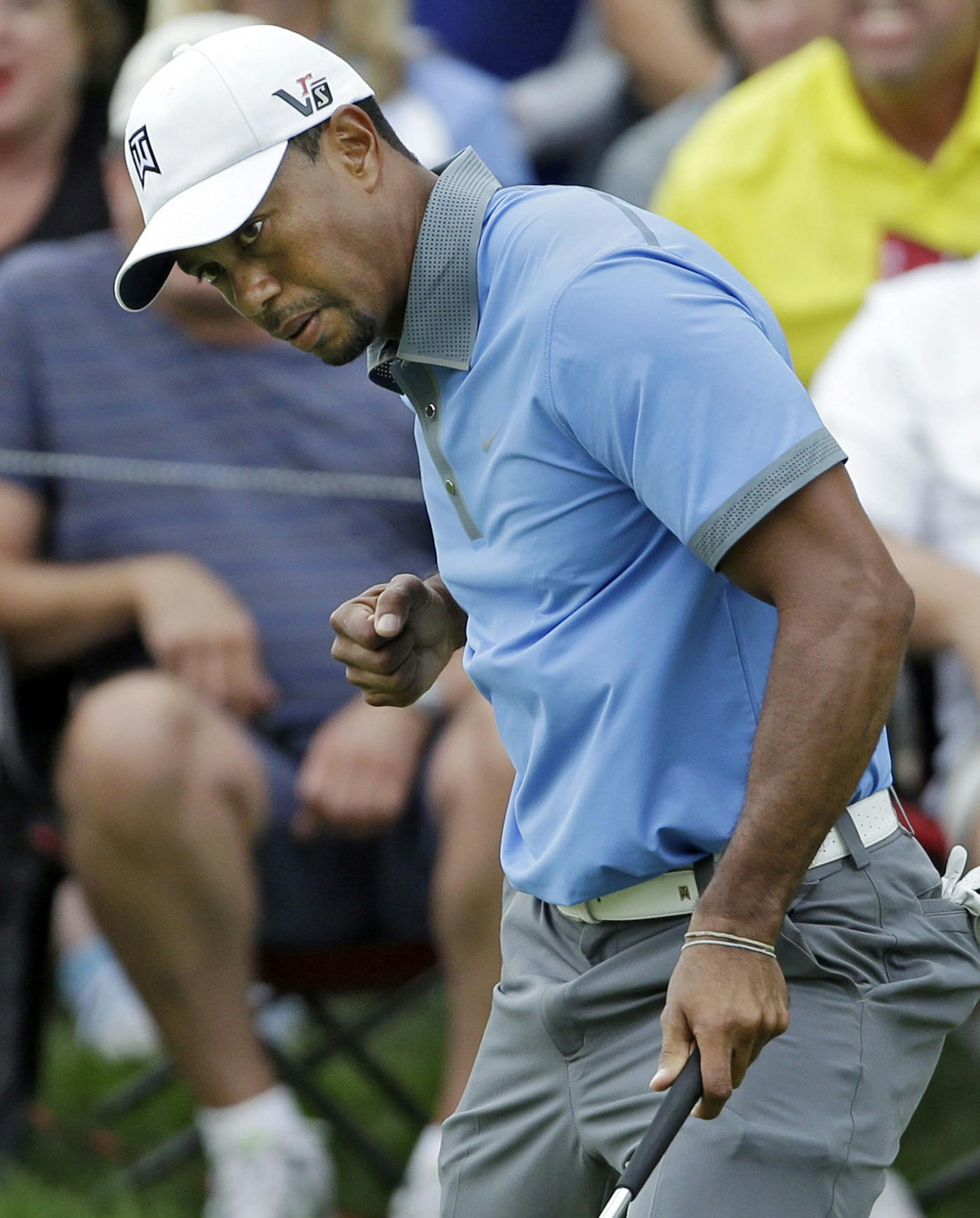 Tiger Woods celebrates a birdie on the 12th hole during the second round of the Bridgestone Invitational golf tournament Friday, Aug. 2, 2013 at Firestone Country Club in Akron, Ohio. Woods shot nine-under 61 to lead the tournament at 13-under. (AP Photo/Mark Duncan)
