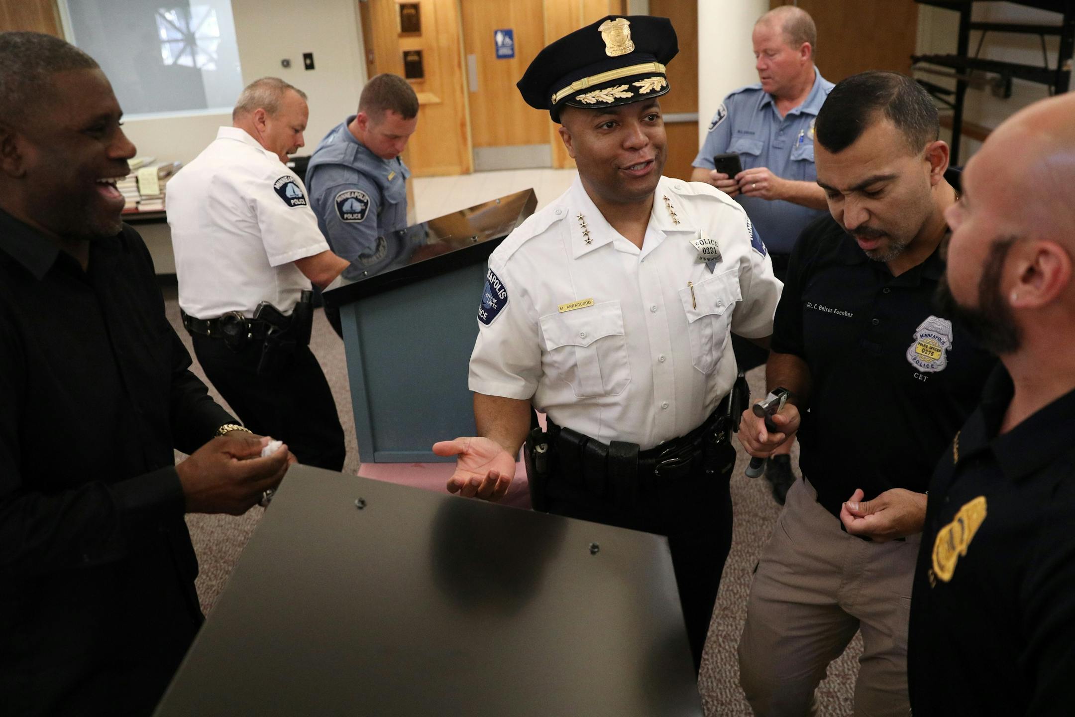 Police Chief Medaria Arradondo teased a group of officers about their speed of their construction as they worked to build free-standing Little Free Libraries Tuesday.