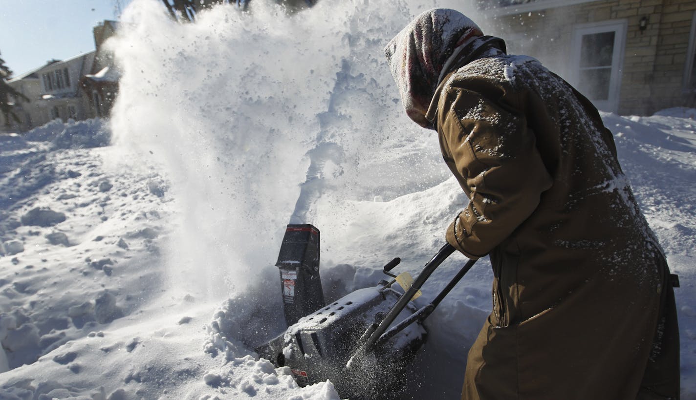 On Portland Ave South, Wanda King helped plow the neighbor's sidewalk with her snowblower.