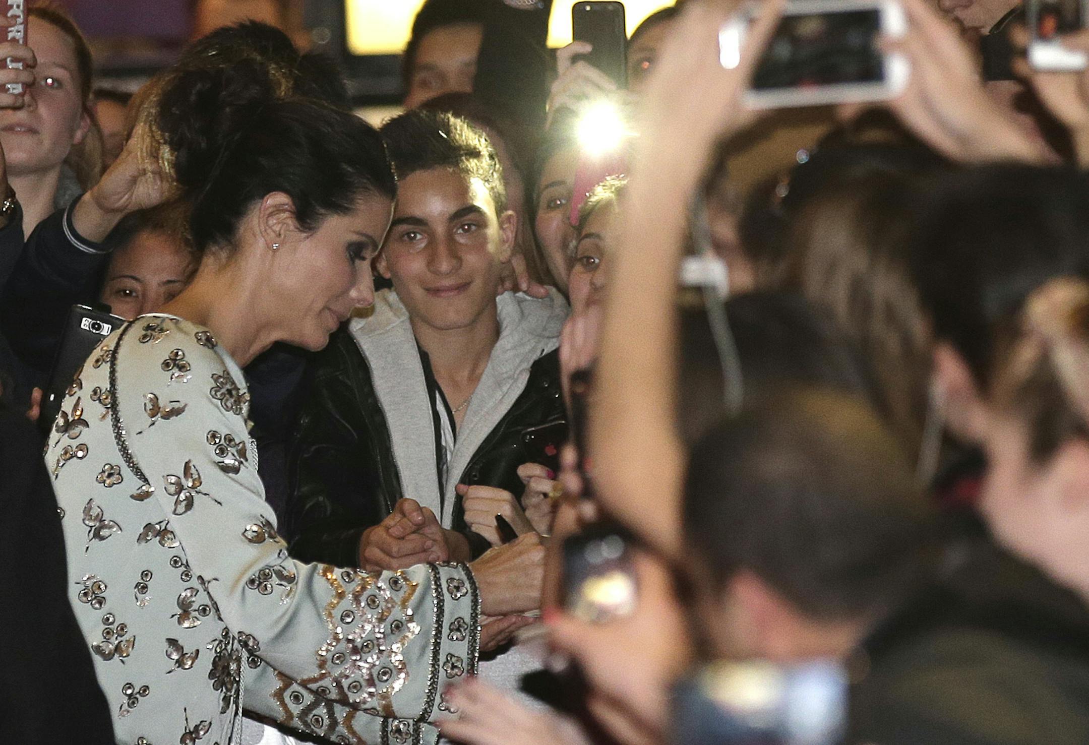 Movie star Sandra Bullock signs autographs for fans during the premiere of her new film "Heat" in Sydney, Australia, Tuesday, July 2, 2013. (AP Photo/Rob Griffith)