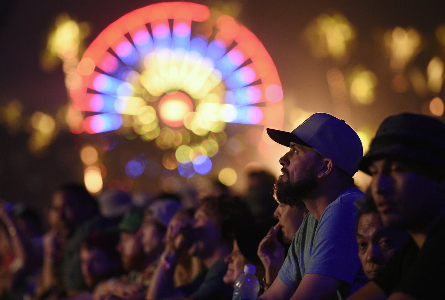 A festival goer watches Bob Dylan's performance on day 1 of the 2016 Desert Trip music festival at Empire Polo Field on Friday, Oct. 7, 2016, in Indio, Calif. (Photo by Chris Pizzello/Invision/AP)