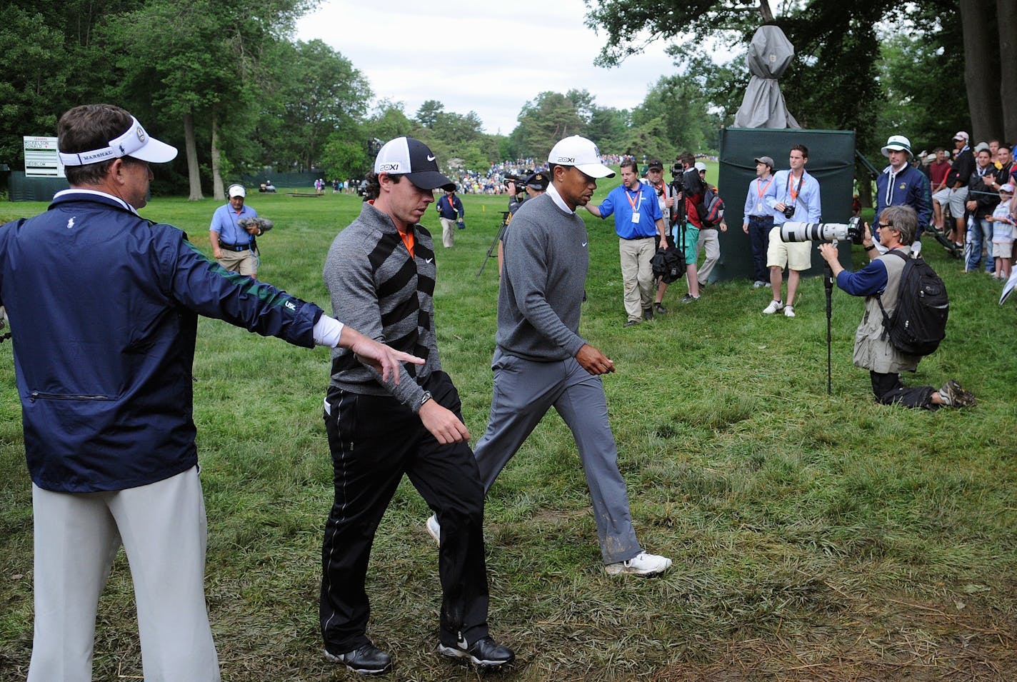 Rory McIlroy, left, and Tiger Woods, right, walk off the 11th hole during the second round of the U.S. Open golf tournament at Merion Golf Club Friday, June 14, 2013, in Ardmore, Pa. (AP Photo/The Express-Times, Matt Smith)