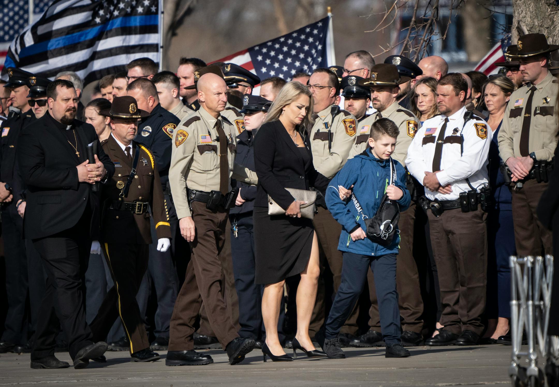 Wife of Pope County deputy Josh Owen, Shannon Owen, arrives with their son Rylan for the visitation and funeral of Deputy Josh Owen.
