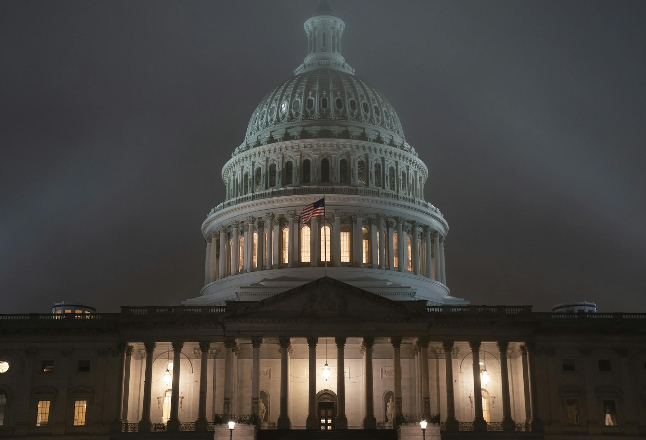 The U.S. Capitol in Washington is shrouded in mist, Friday night, Dec. 13, 2019, at the end of an acrimonious week of partisan disputes in the House Judiciary Committee which approved two articles of impeachment against President Donald Trump, Friday, Dec. 13, 2019. The full House of Representatives, controlled by the Democrats, is expected to vote on the charges of abuse of power and obstruction of Congress before lawmakers depart for the holidays. (AP Photo/J. Scott Applewhite)