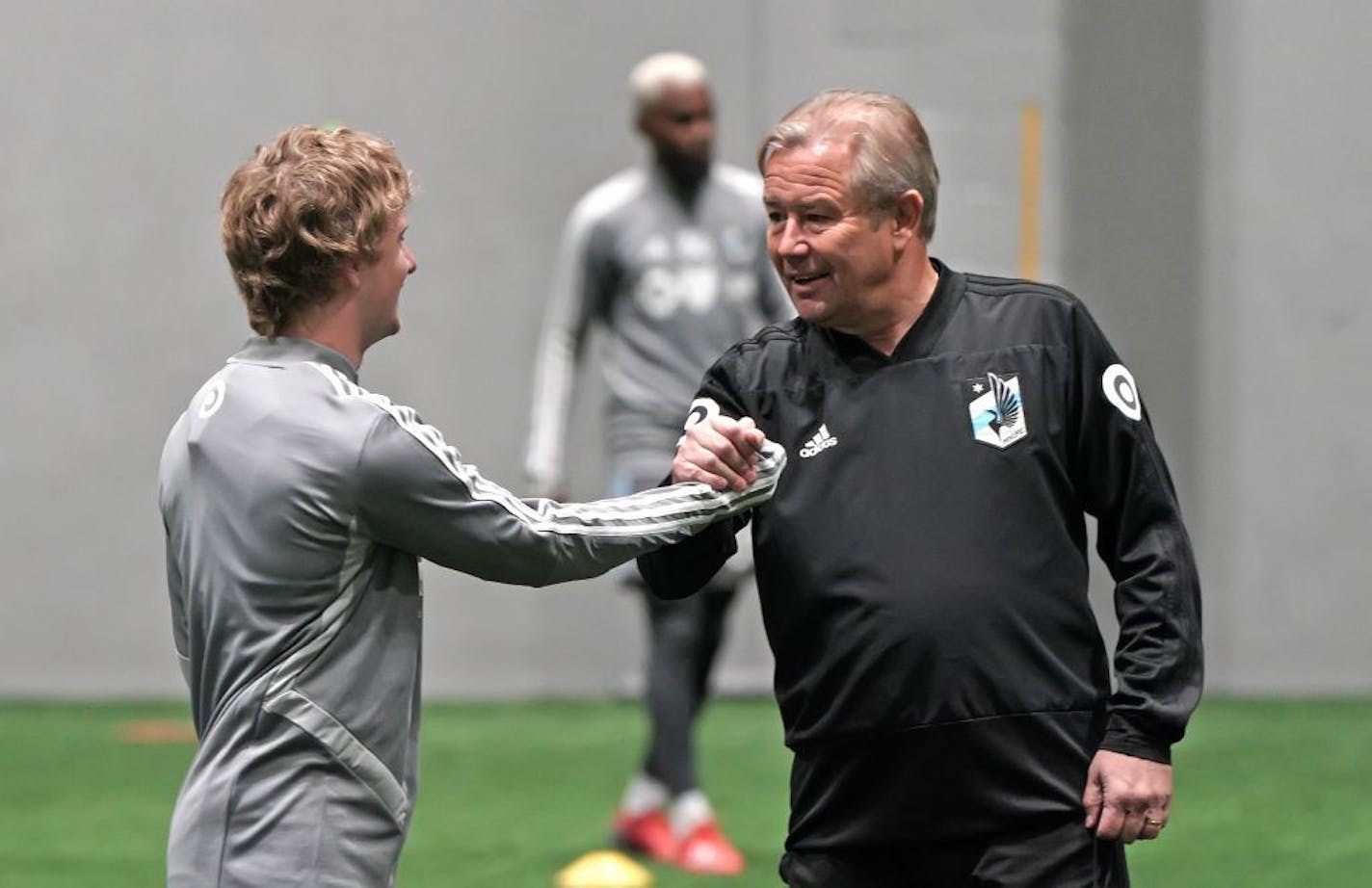 Thomas Chacon is welcomed by United coach Adrian Heath.