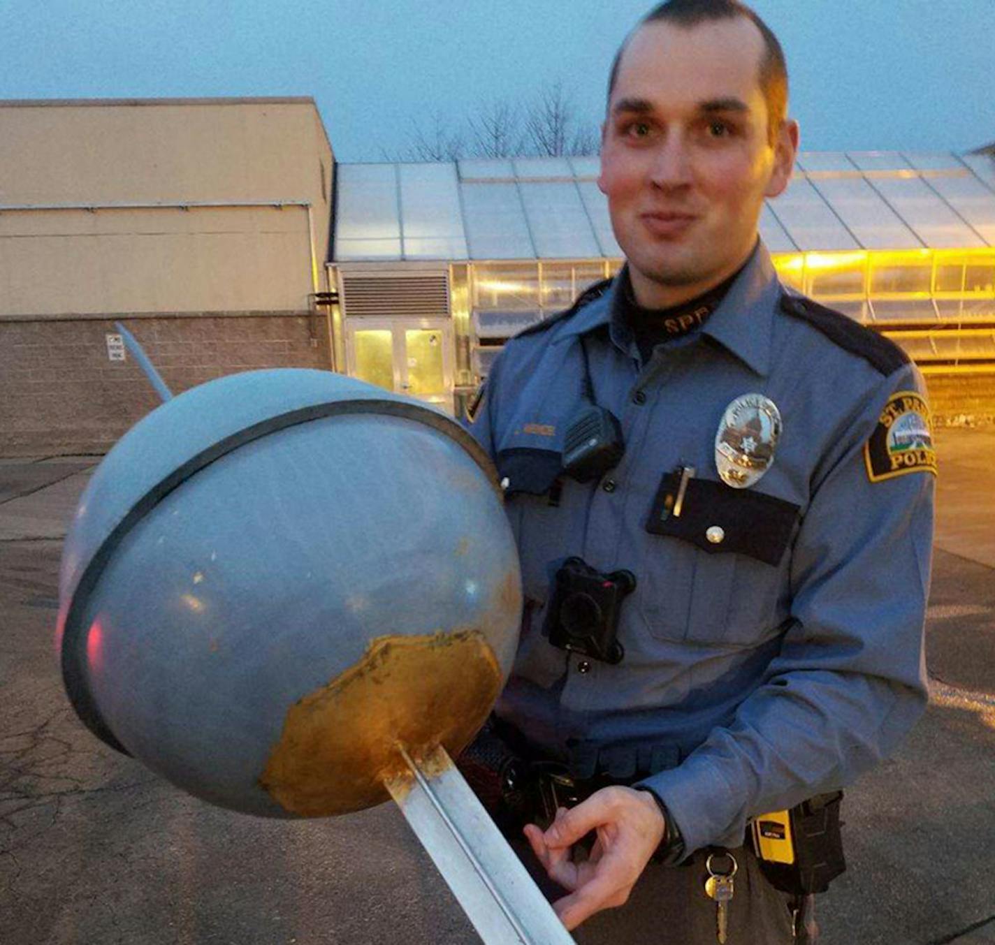 A St. Paul police officer holding the found finial on Tuesday night.