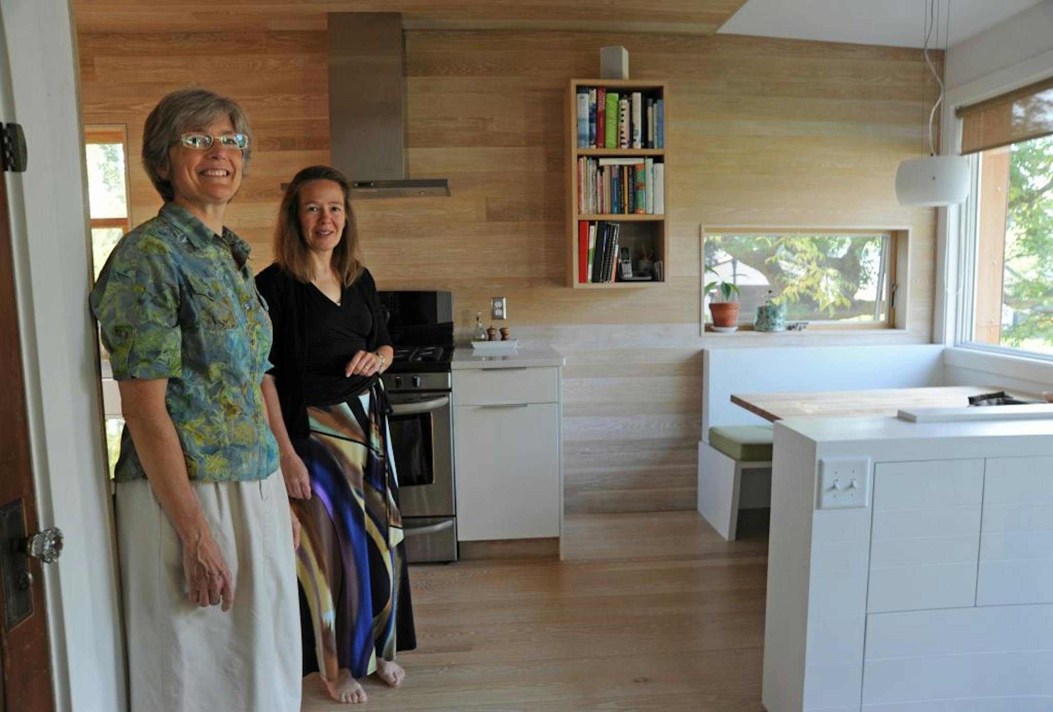 Kathy Wallace and Sarah Pradtat home in the kitchen area . This is a Homes cover story about a project the architect has dubbed "Minmojasca" (Minnesota modern Japanese Scandinavian). It's a solar addition that heats the house, with Japanese and Scandinavian design influences.