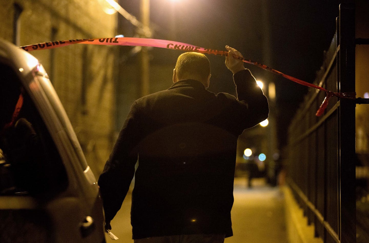 A member of the Chicago Police Department walked under police tape at the scene of an officer-involved shooting.