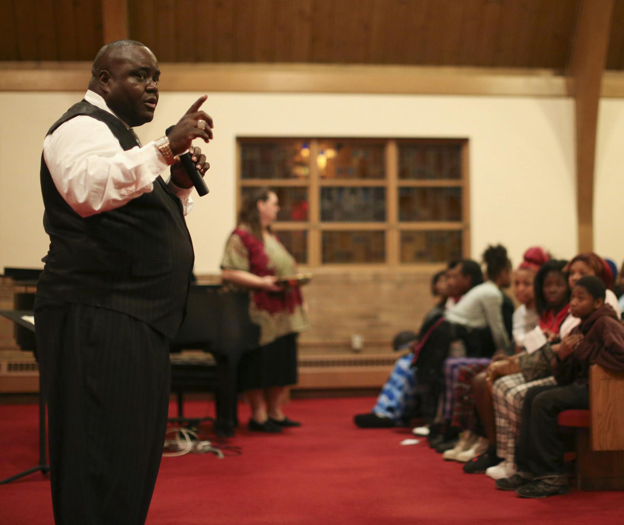 Pastor Harding Smith spoke before an offering was collected to benefit the family of the three children killed in the fire during the vigil Wednesday night at Elim Lutheran Church. ] JEFF WHEELER &#xef; jeff.wheeler@startribune.com Pastor Harding Smith led a vigil for the family of the three children killed in a fire last weekend. Community members and family gathered at Elim Lutheran Church in Robbinsdale Wednesday night, October 7, 2015. The church that Smith leads normally worships in leased