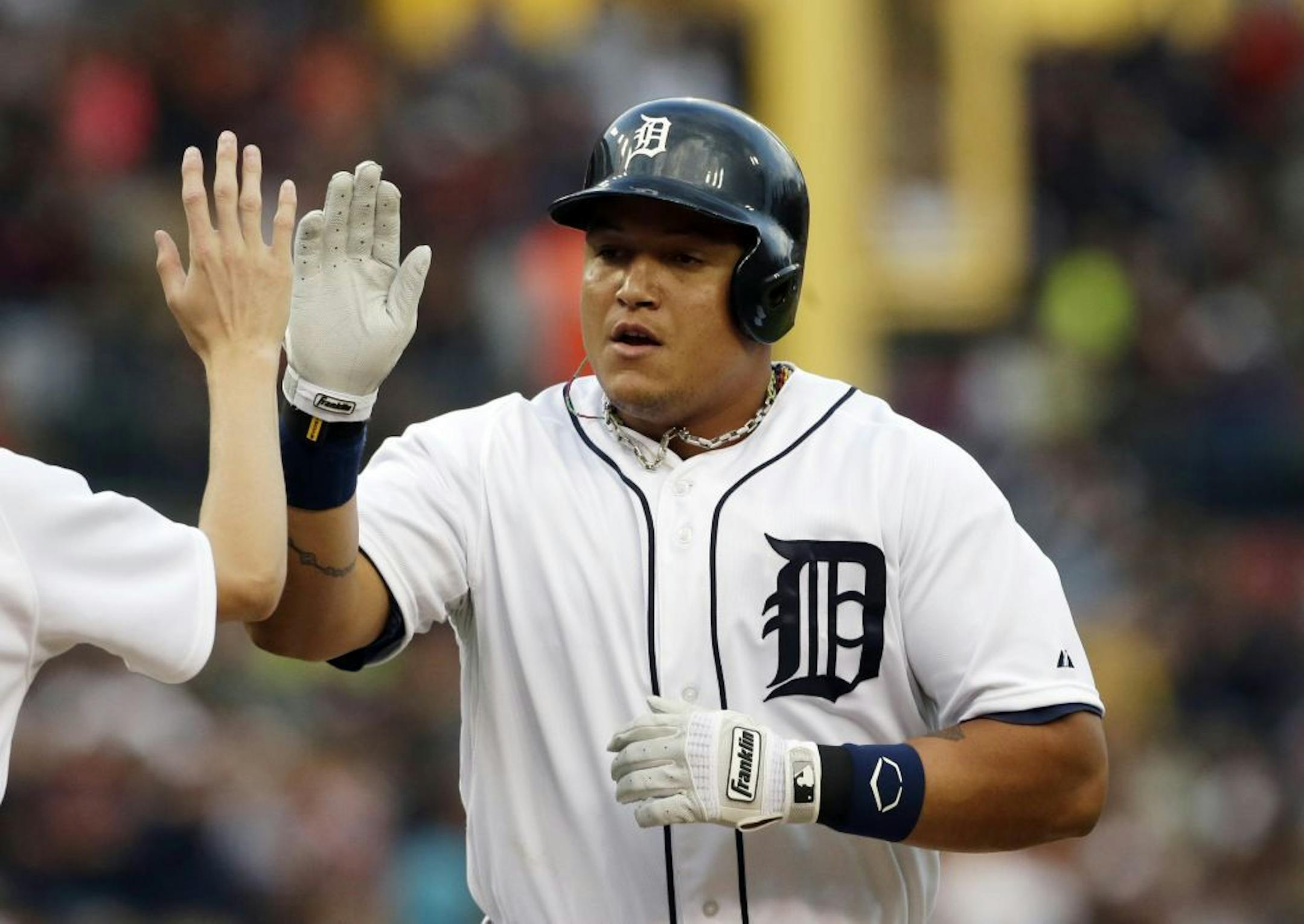 Detroit Tigers' Miguel Cabrera is congratulated after his solo home run during the first inning of a baseball game against the Philadelphia Phillies in Detroit, Saturday, July 27, 2013.