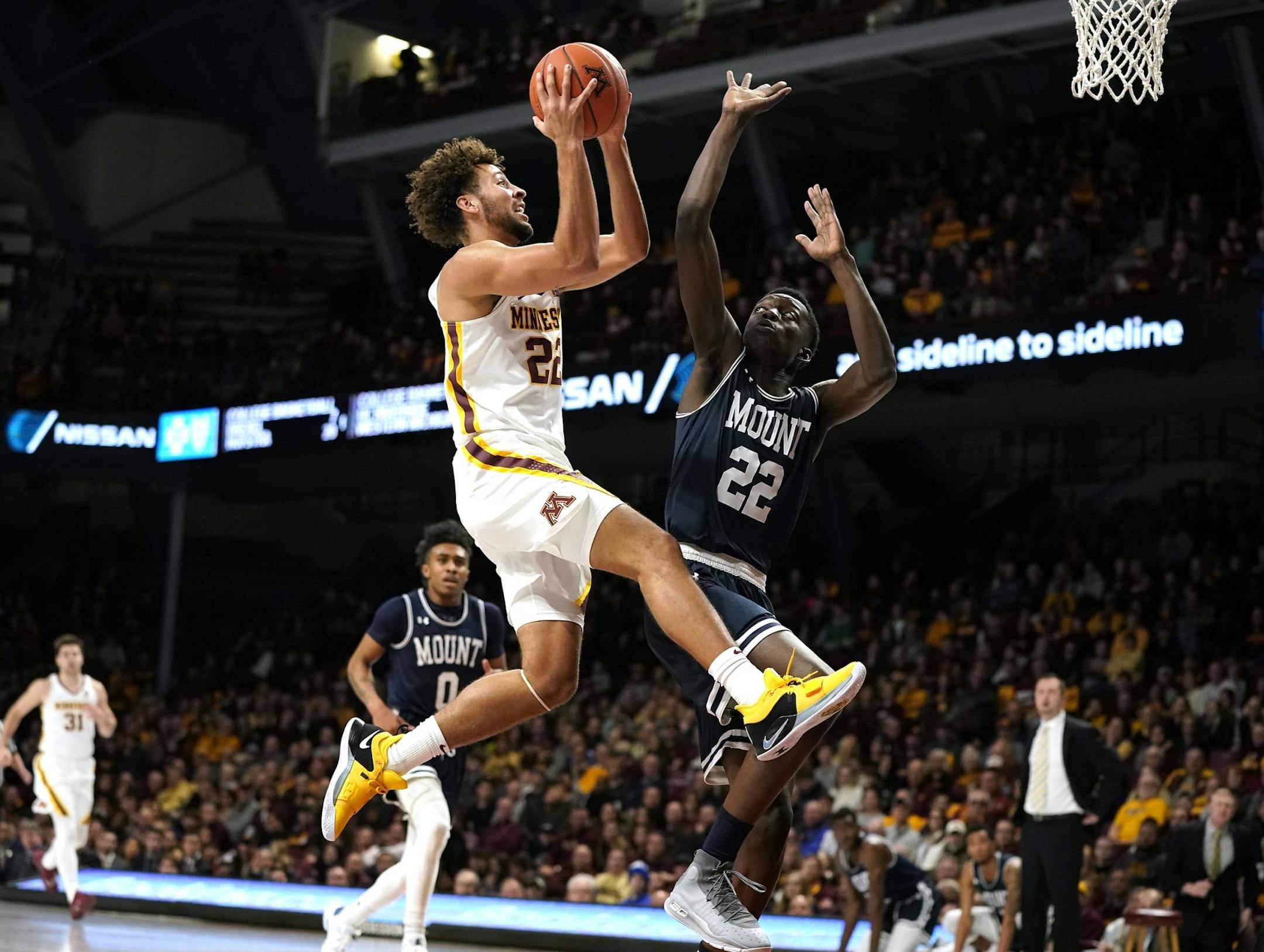 Minnesota guard Gabe Kalscheur (22) shoots as Mount St. Mary's forward Nana Opoku (22) defends during the first half.