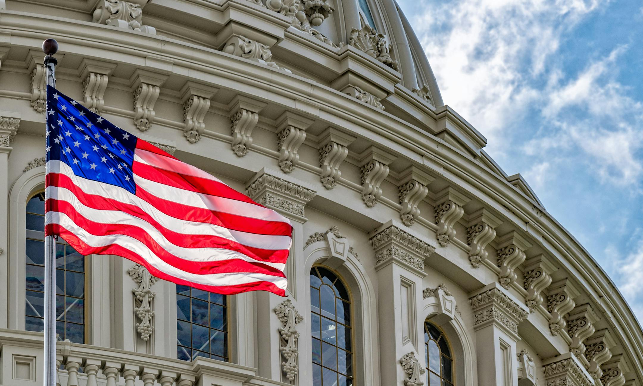 Washington DC Capitol dome detail with waving american flag