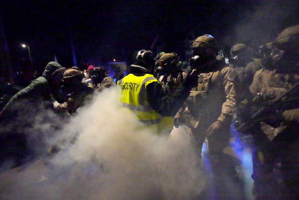 Federal agents deploy chemical irritants as they try to push demonstrators further from the scene where a federal agent shot a man in north Minneapolis on Wednesday, Jan. 14.