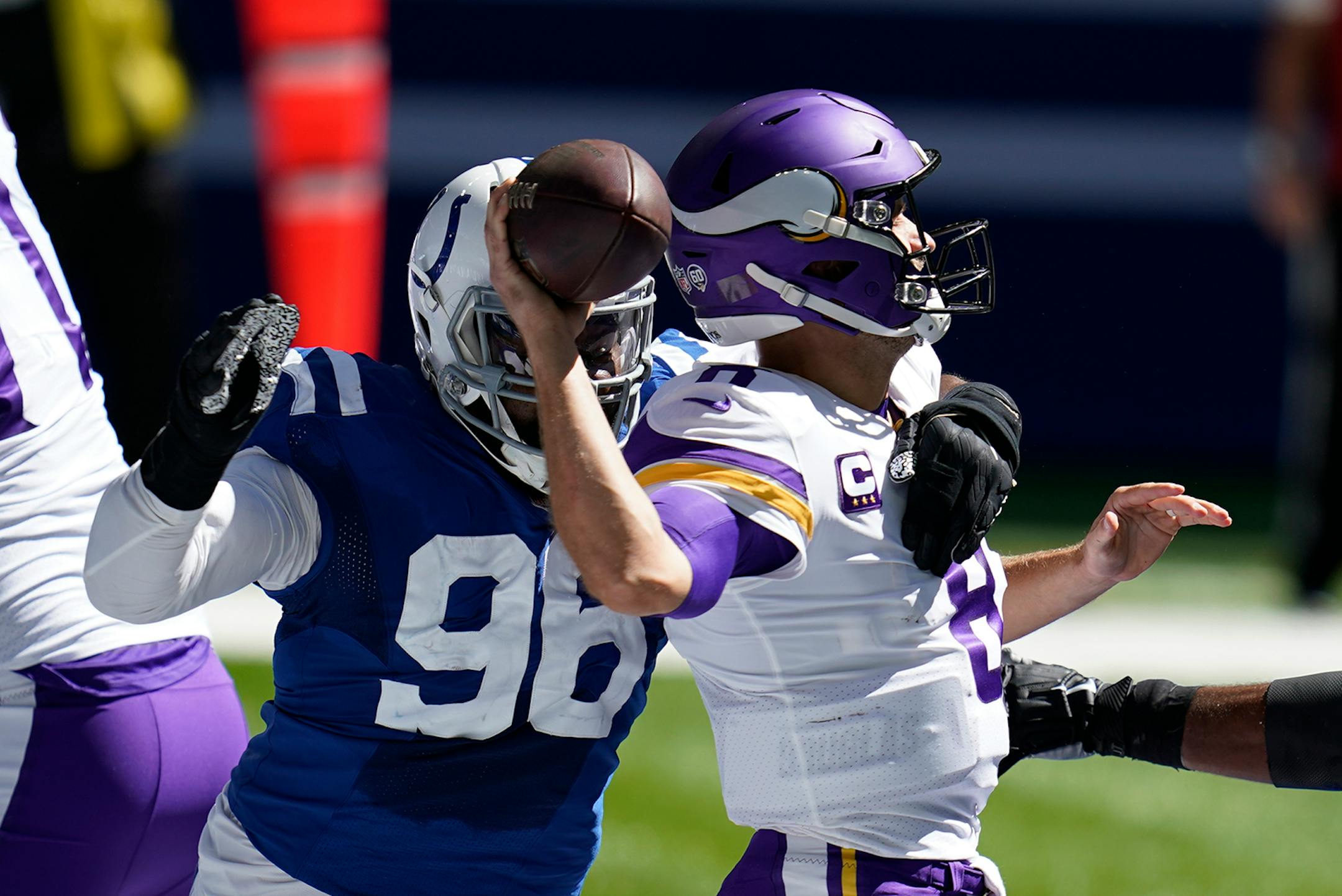 Minnesota Vikings quarterback Kirk Cousins, right, is pressured by dIndianapolis Colts' Denico Autry (96) during the first half of an NFL football game, Sunday, Sept. 20, 2020, in Indianapolis.