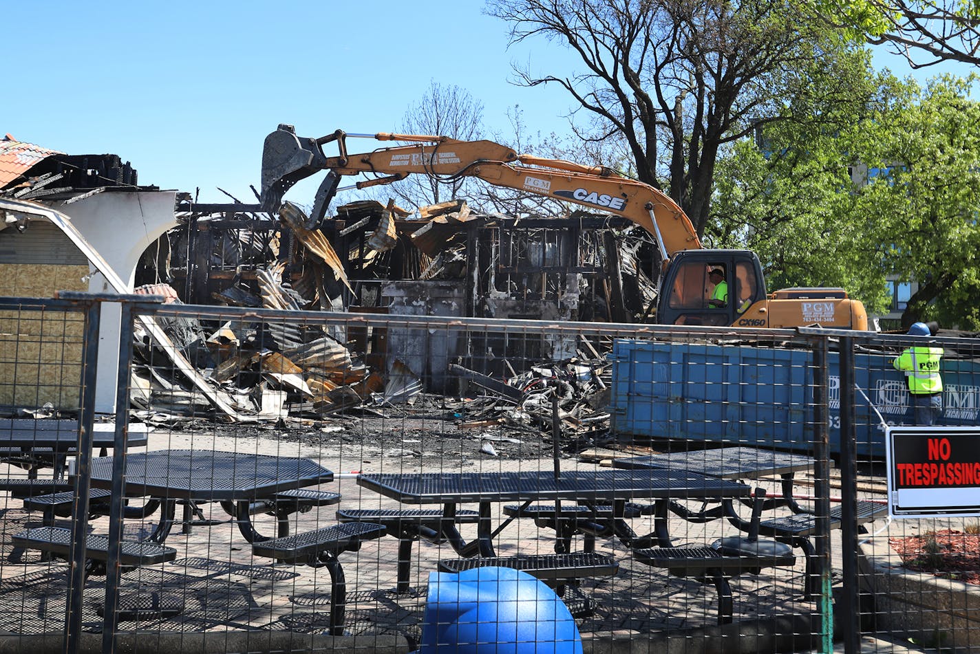 An excavator tears down the remnants of Lola on the Lake at the pavilion at Bde Maka Ska/Lake Calhoun, damaged beyond repair during a recent fire and seen Tuesday, May 28, 2019, in Minneapolis, MN.