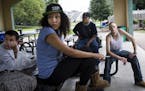 Deante Brown, left, Yana Miller, J.D. (last name withheld) and Stephen Rose relaxed at the picnic shelter at Akin Riverside Park in Anoka last week. T