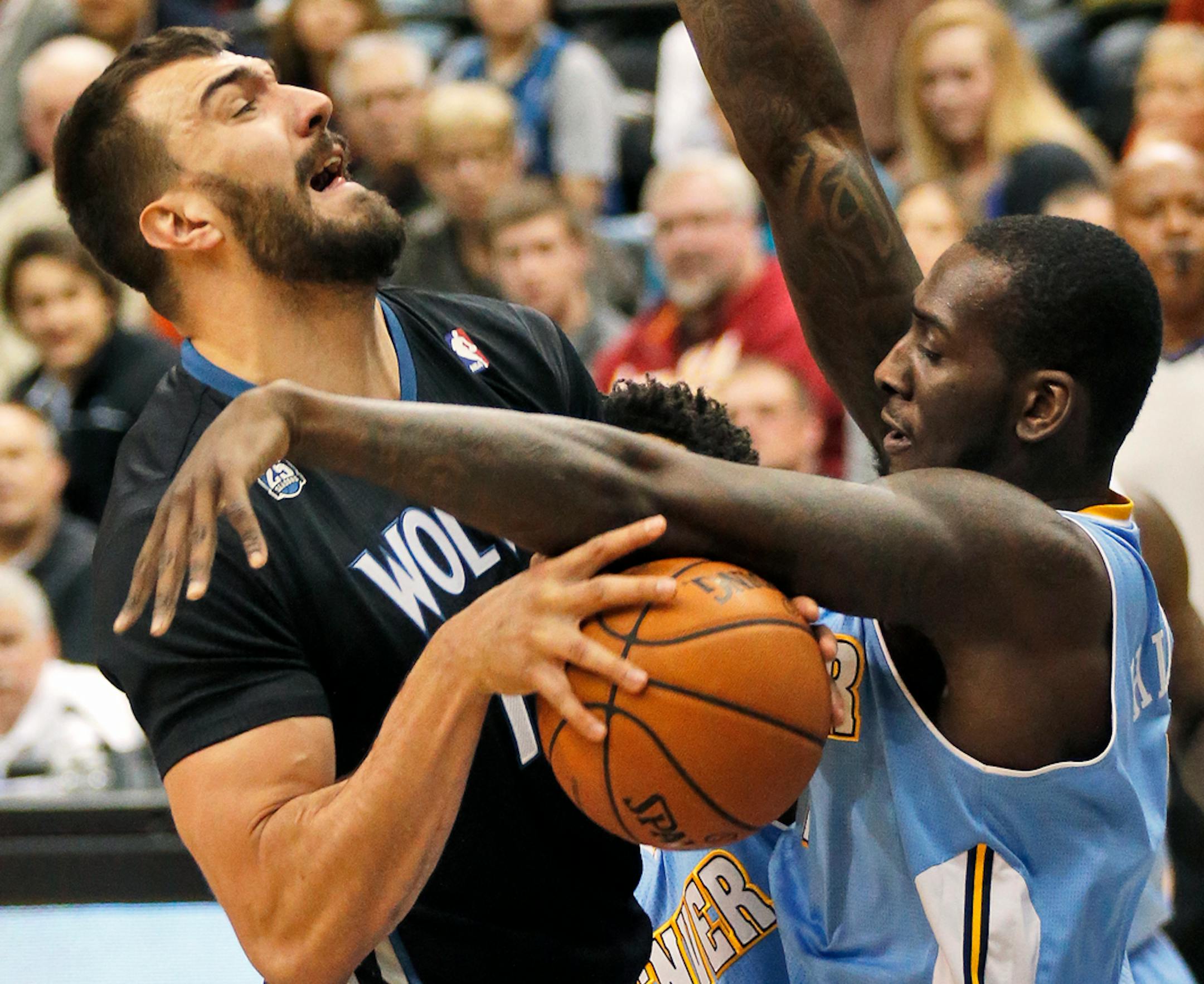 Minnesota Timberwolves vs. Denver Nuggets. Wolves Nikola Pekovic, left, was fouled by Denver's J.J. Hickson in first quarter action.