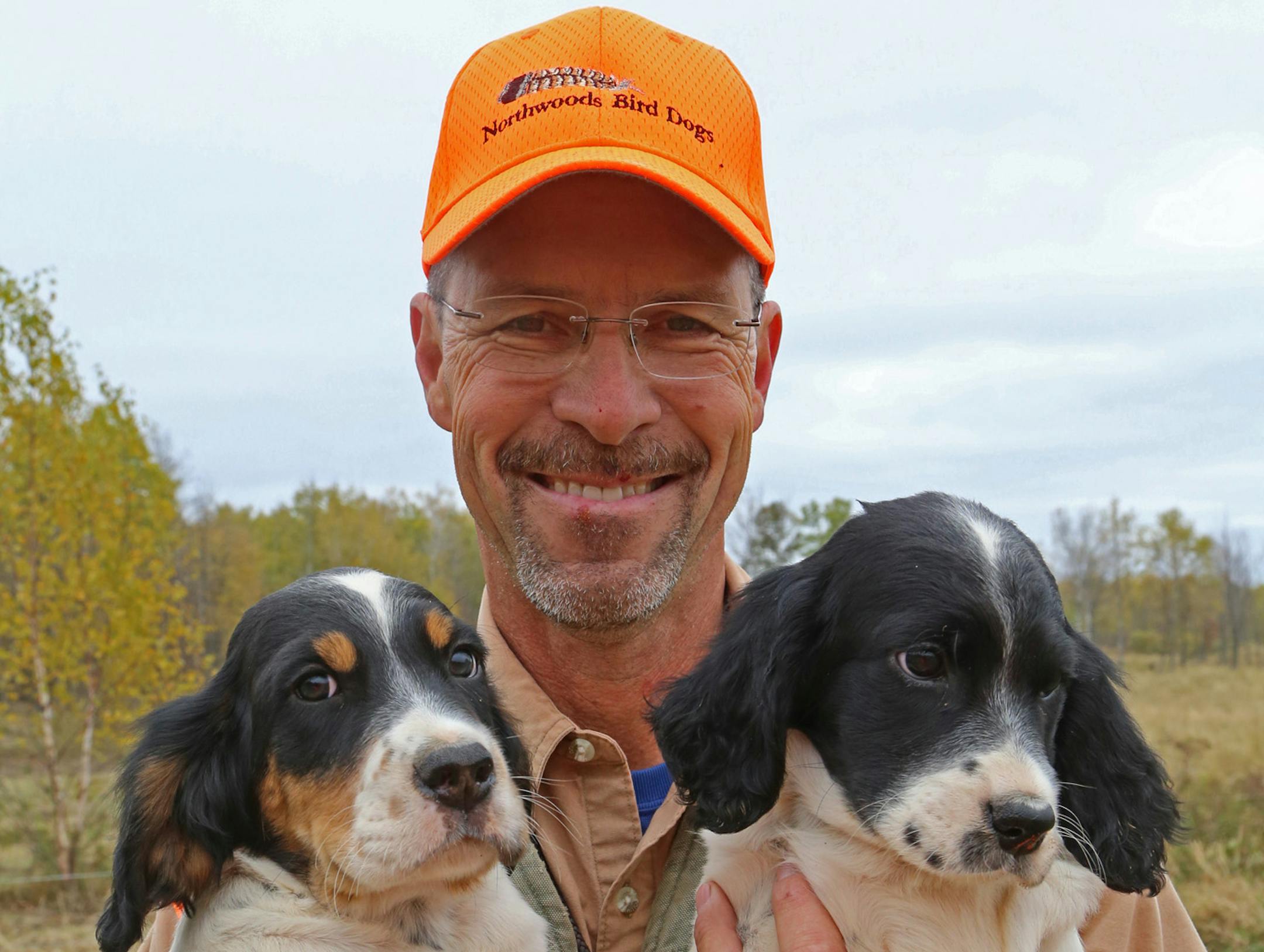 Jerry Kolter's affection for a pair of young English setters is borne in his smile &#x201a;&#xc4;&#xee; though the puppies appear slightly worried by the guy taking their photograph. ORG XMIT: MIN1410092256484892