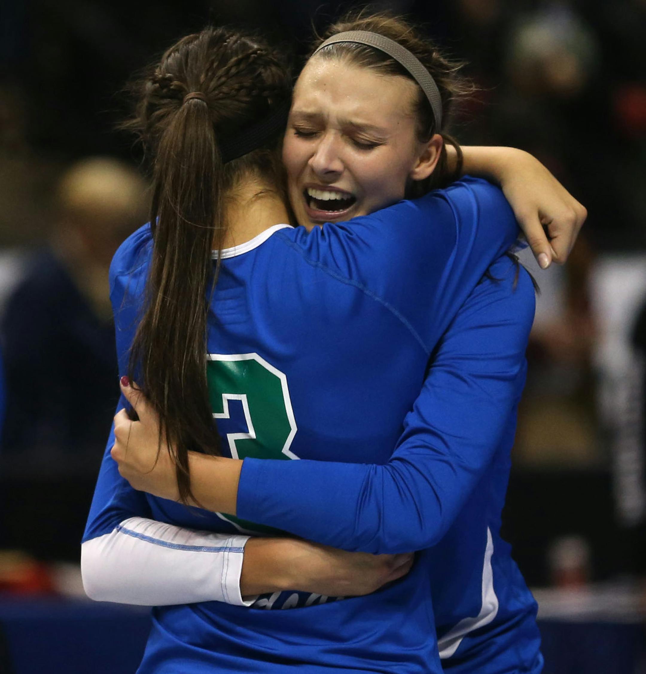 Eagan sisters Taylr and Madeline McNeil hugged after winning the state championship Class 3A finals at the Xcel Energy Center in St. Paul, Min., Saturday, November 9, 2013. Eagan won over Delano 3-2. ] (KYNDELL HARKNESS/STAR TRIBUNE) kyndell.harkness@startribune.com