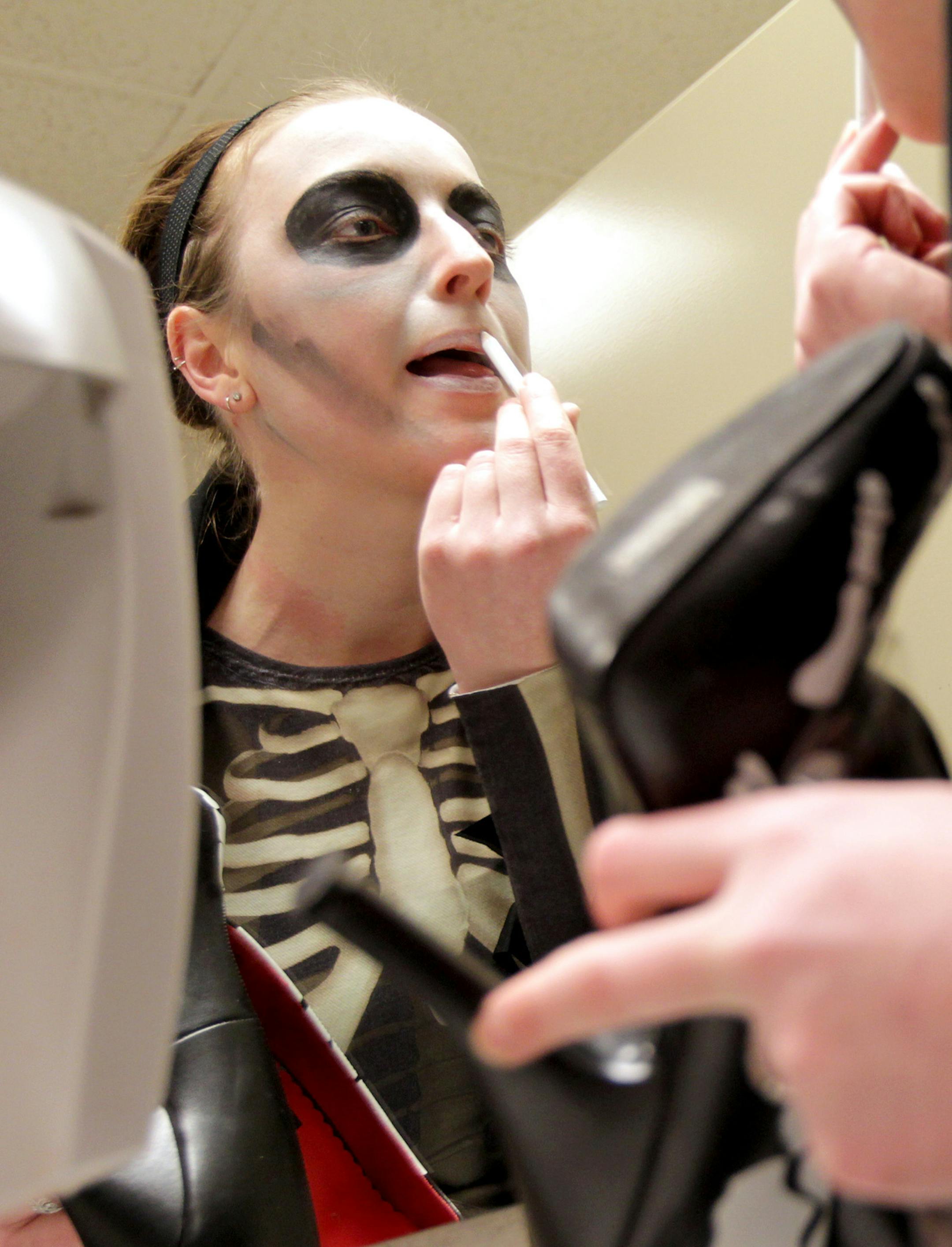 Angela "Death" Hershberger applies makeup before the Minnesota Arm Wrestling League for Ladies holds a brief set of matches at the Minnesota Roller Girls tournament at Roy Wilkins Auditorium in St. Paul March 2, 2013. (Courtney Perry/Special to the Star Tribune)