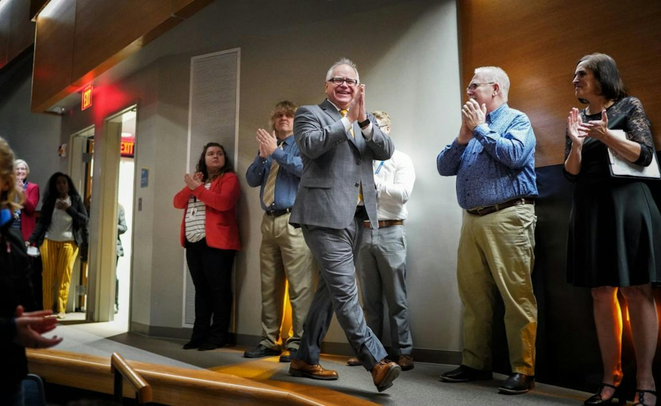 Minnesota Governor Tim Walz acknowledged applause as he arrived at Waseca Junior/Senior High School, where he talked to juniors and seniors and visited with staff.