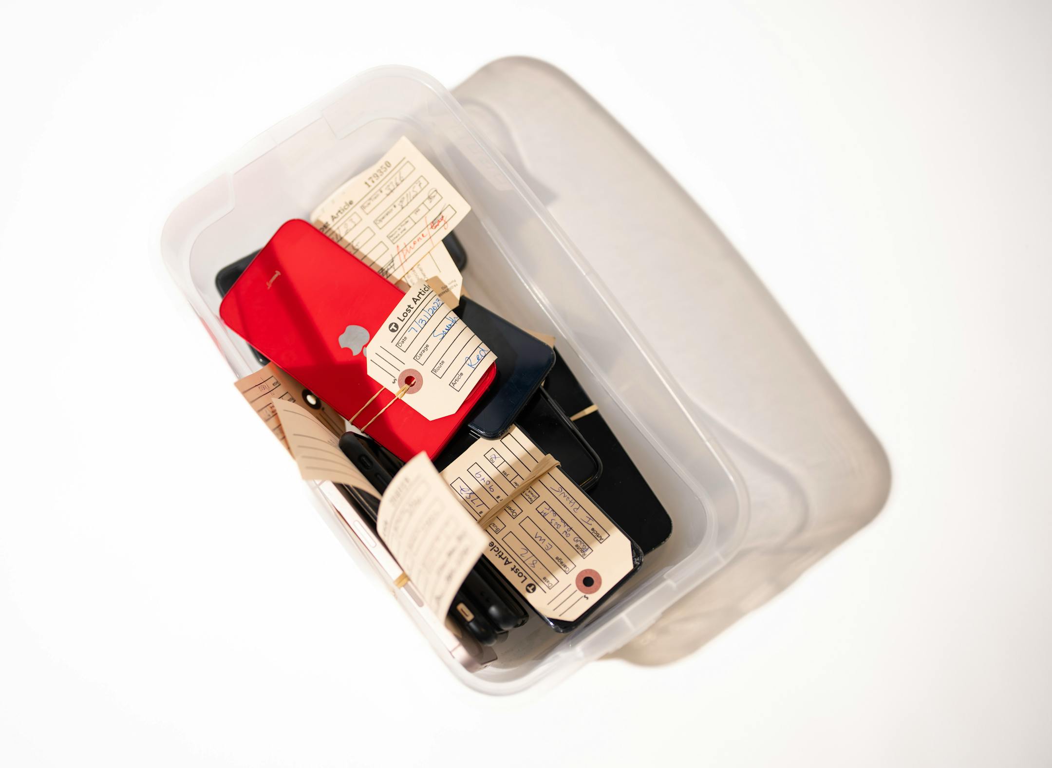 One of several bins of phones left behind on Metro Transit vehicles recently, photographed in the Lost and Found room.